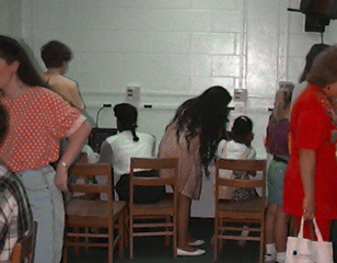 Parents observing their children working on multimedia projects at a technology showcase