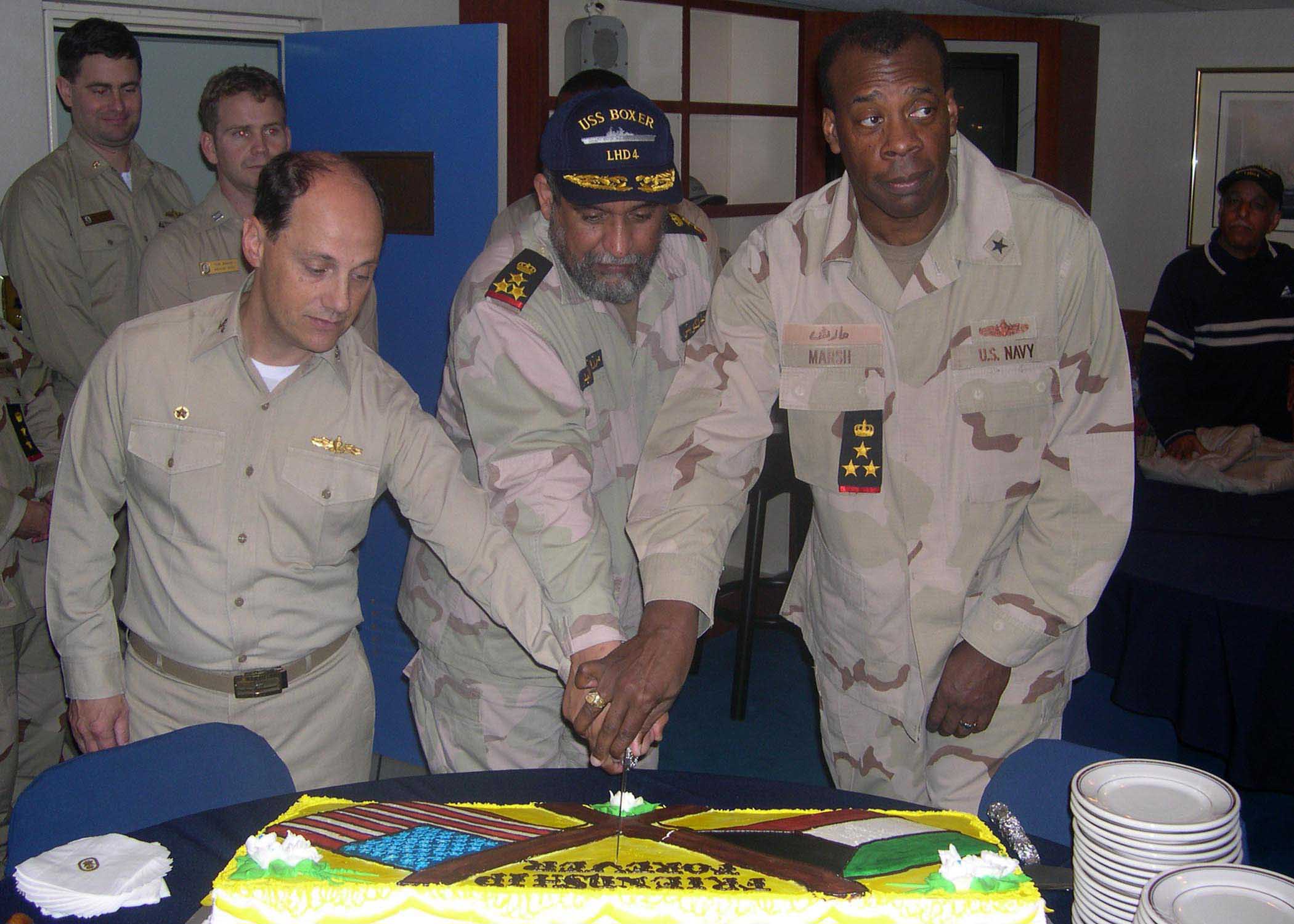 US Navy 040228-N-7912E-001 US Navy and Kuwait officers cut a cake while hosting a friendship meeting aboard the ship.jpg