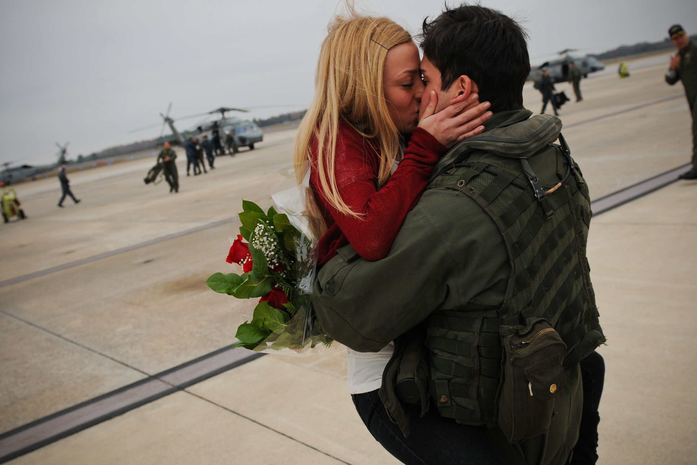 US Navy 101219-N-8590G-002 Aviation Warfare Technician 2nd Class Marc Bellon kisses his girlfriend during a homecoming celebration for the Dusty D.jpg