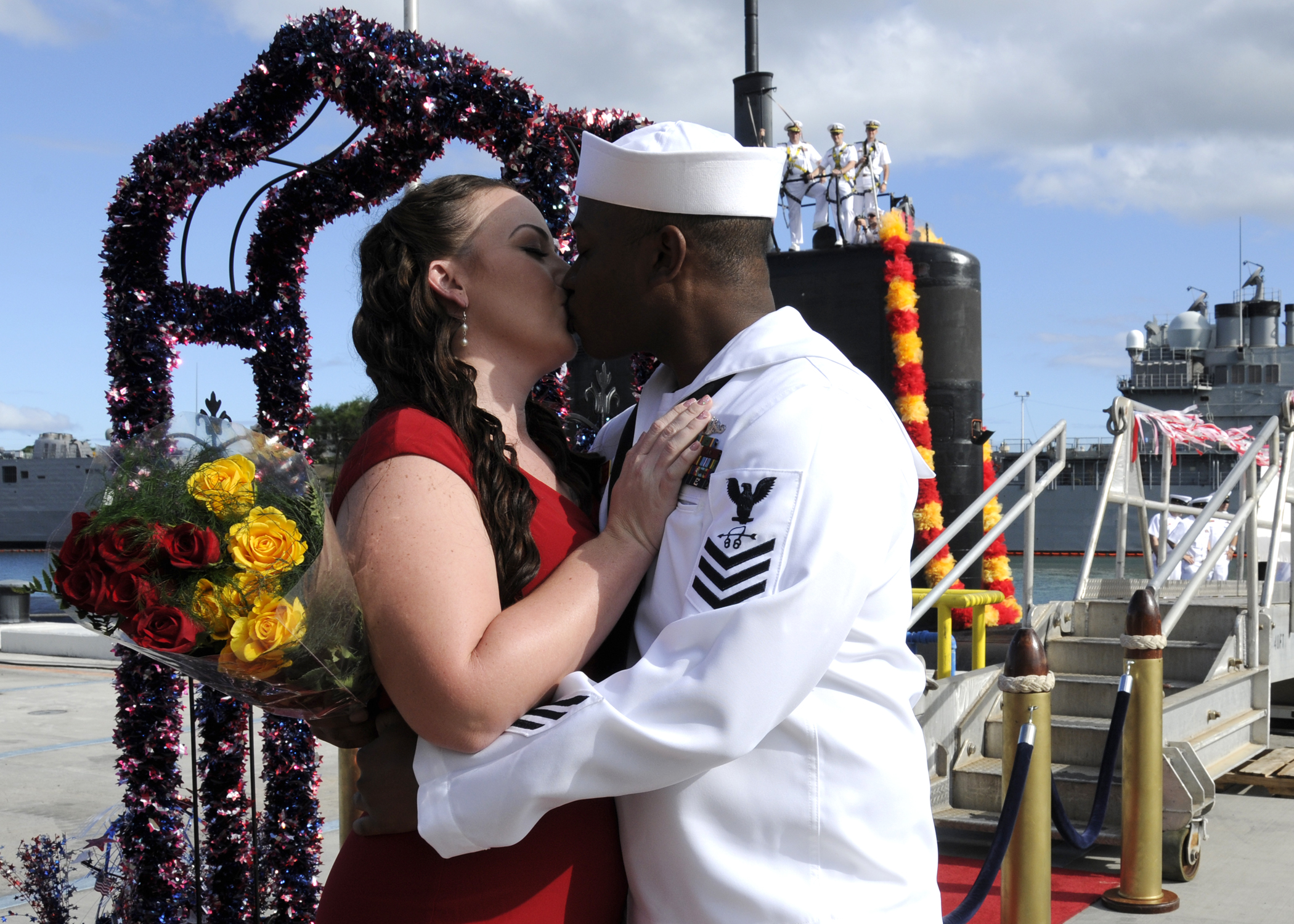 US Navy 110824-N-UK333-077 A Sailor kisses his girlfriend on the pier after returning from a six-month deployment.jpg