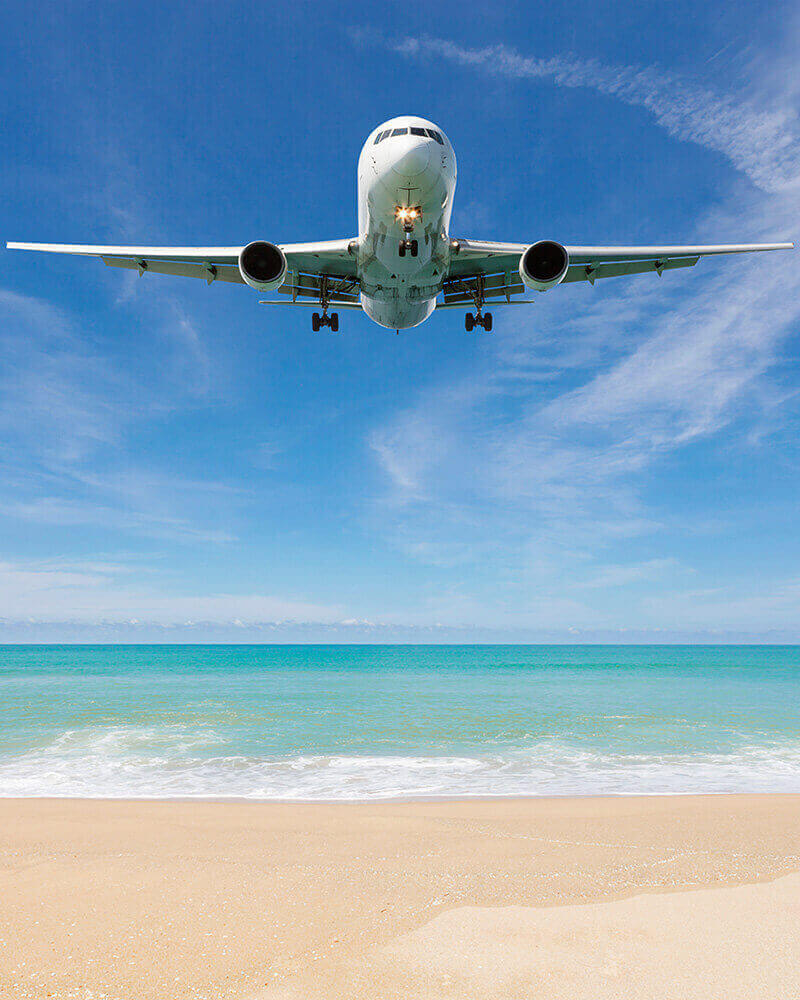 Airplane landing near a beach