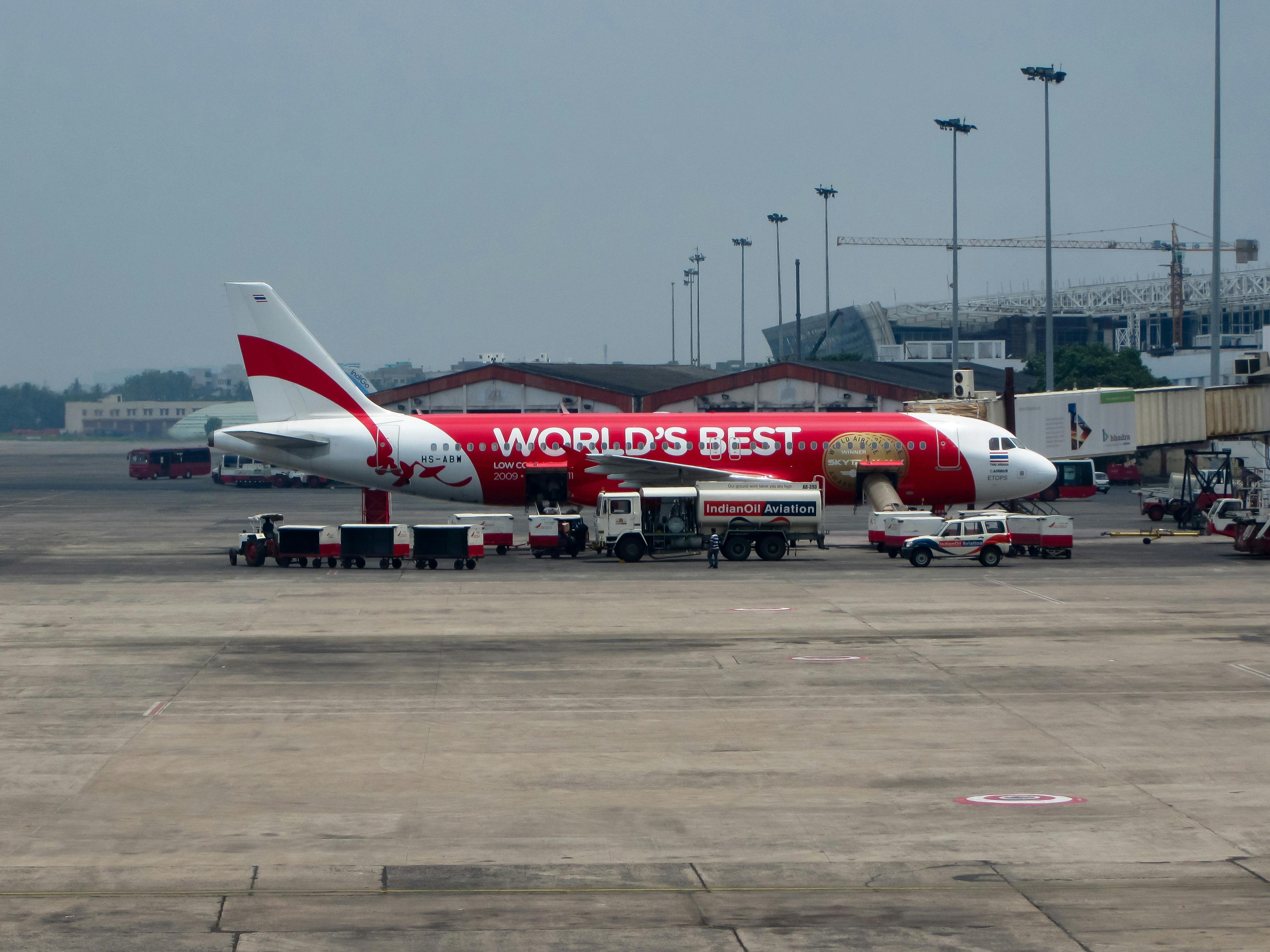 white and red passenger plane on airport