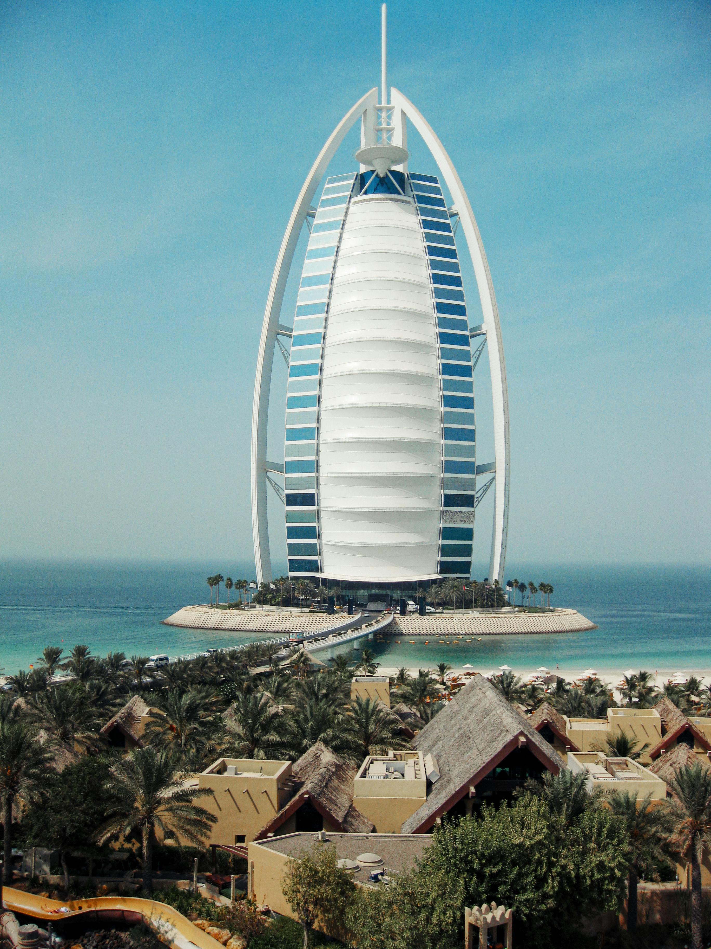 modern architecture and old town with palm tress at waterfront