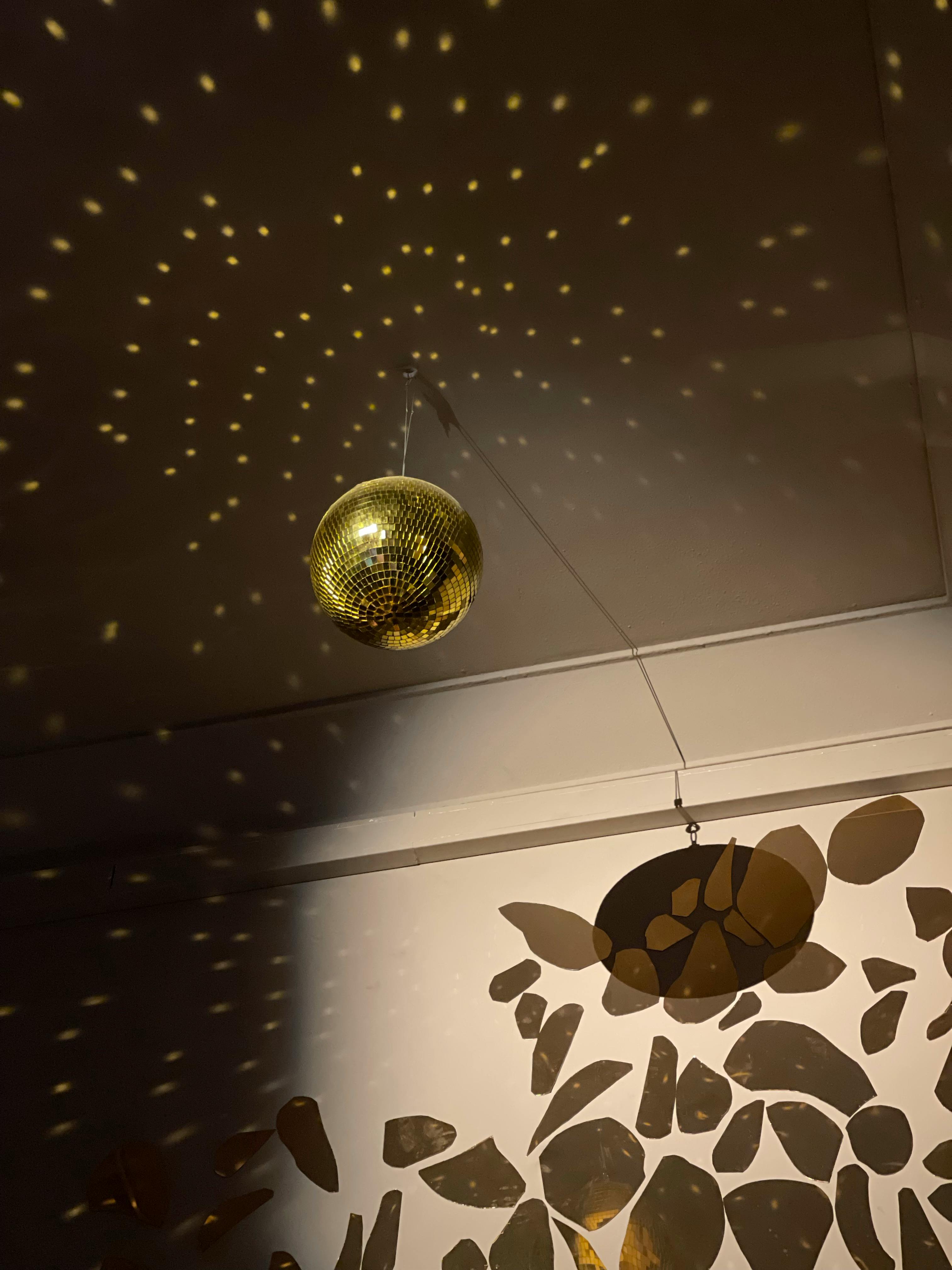 hanging golden disco ball on a ceiling