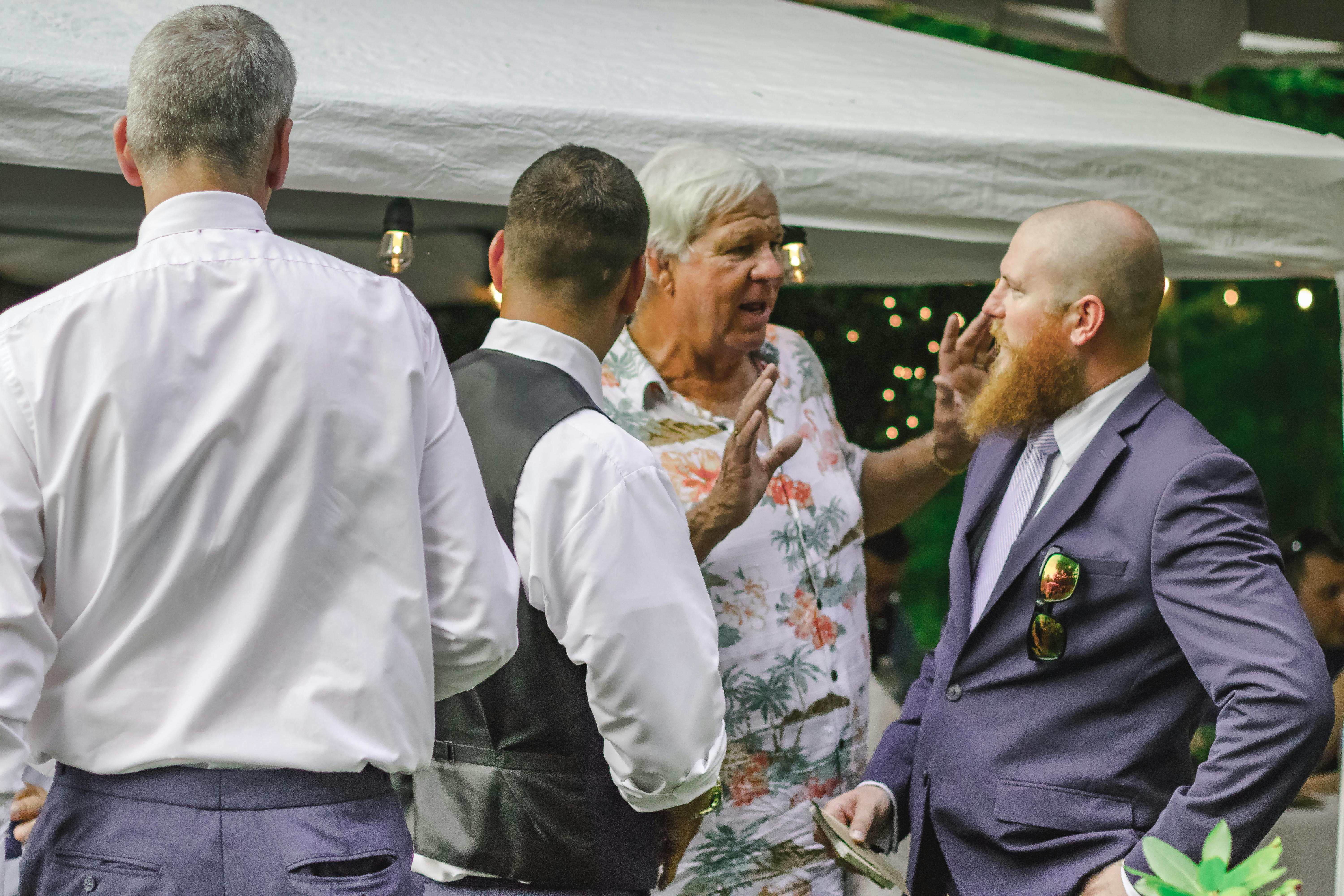 four man standing near canopy tent