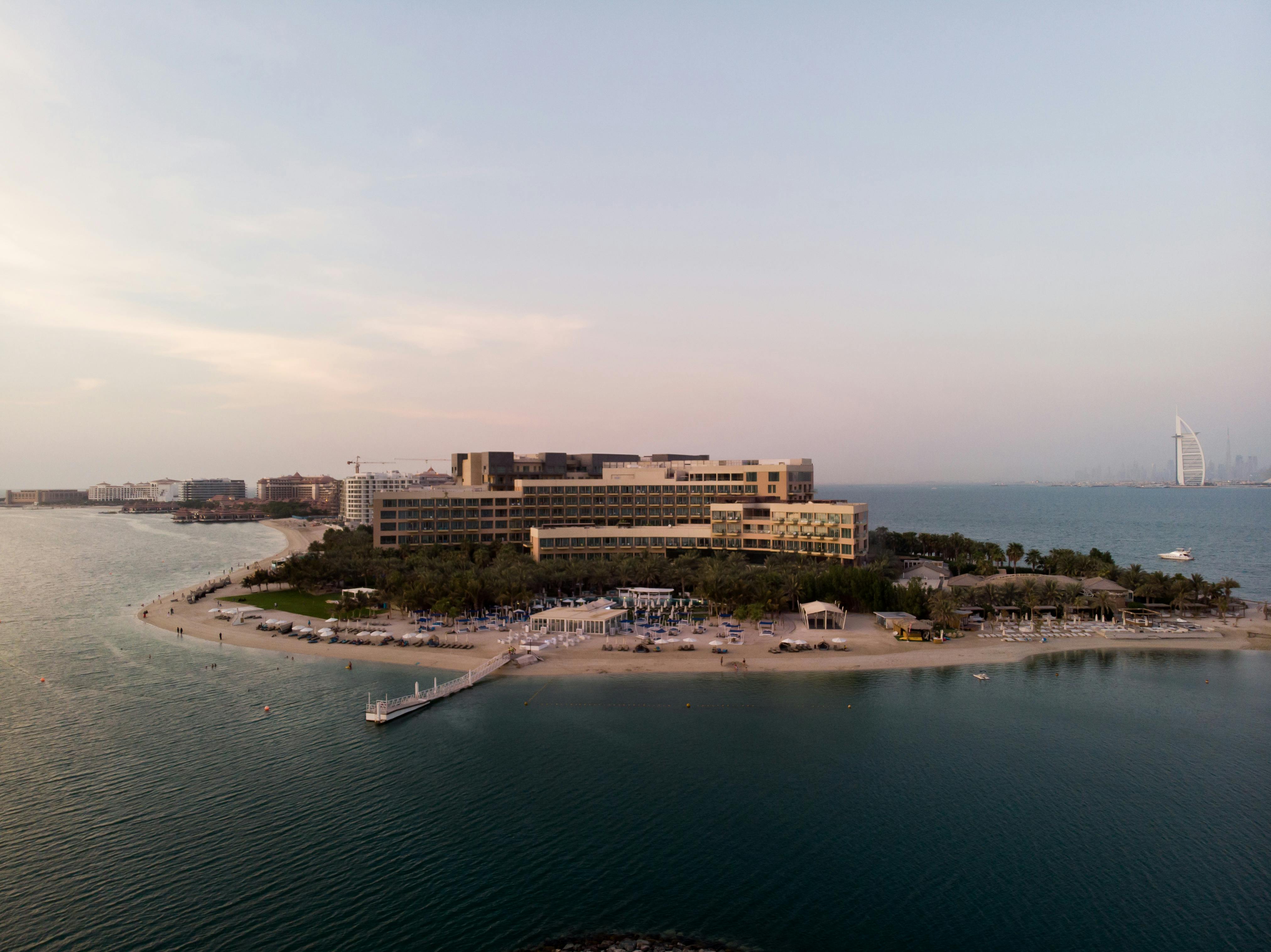 an aerial view of a resort on the water