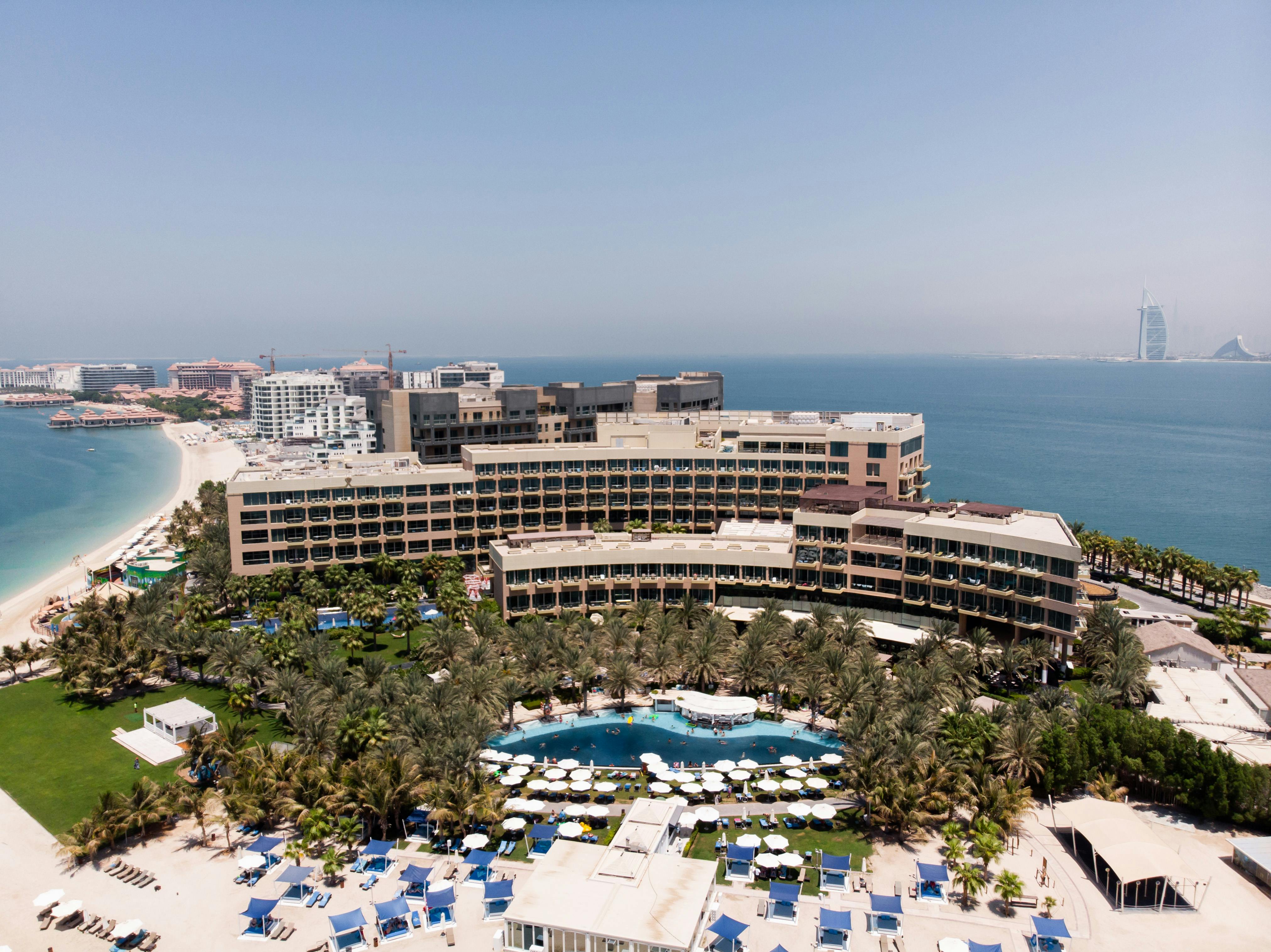 the view of the beach and hotel from the air