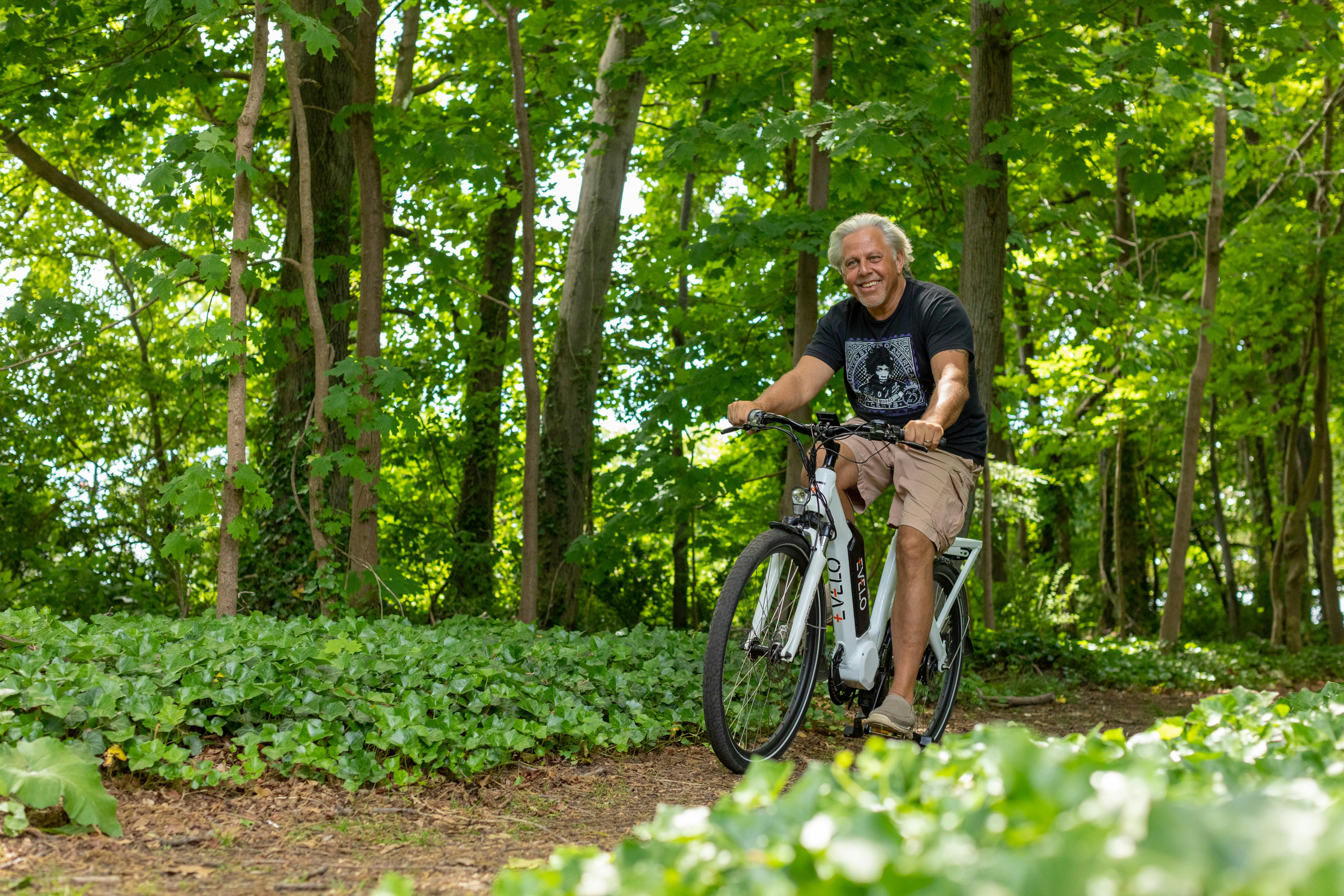 a man riding a bike through a forest