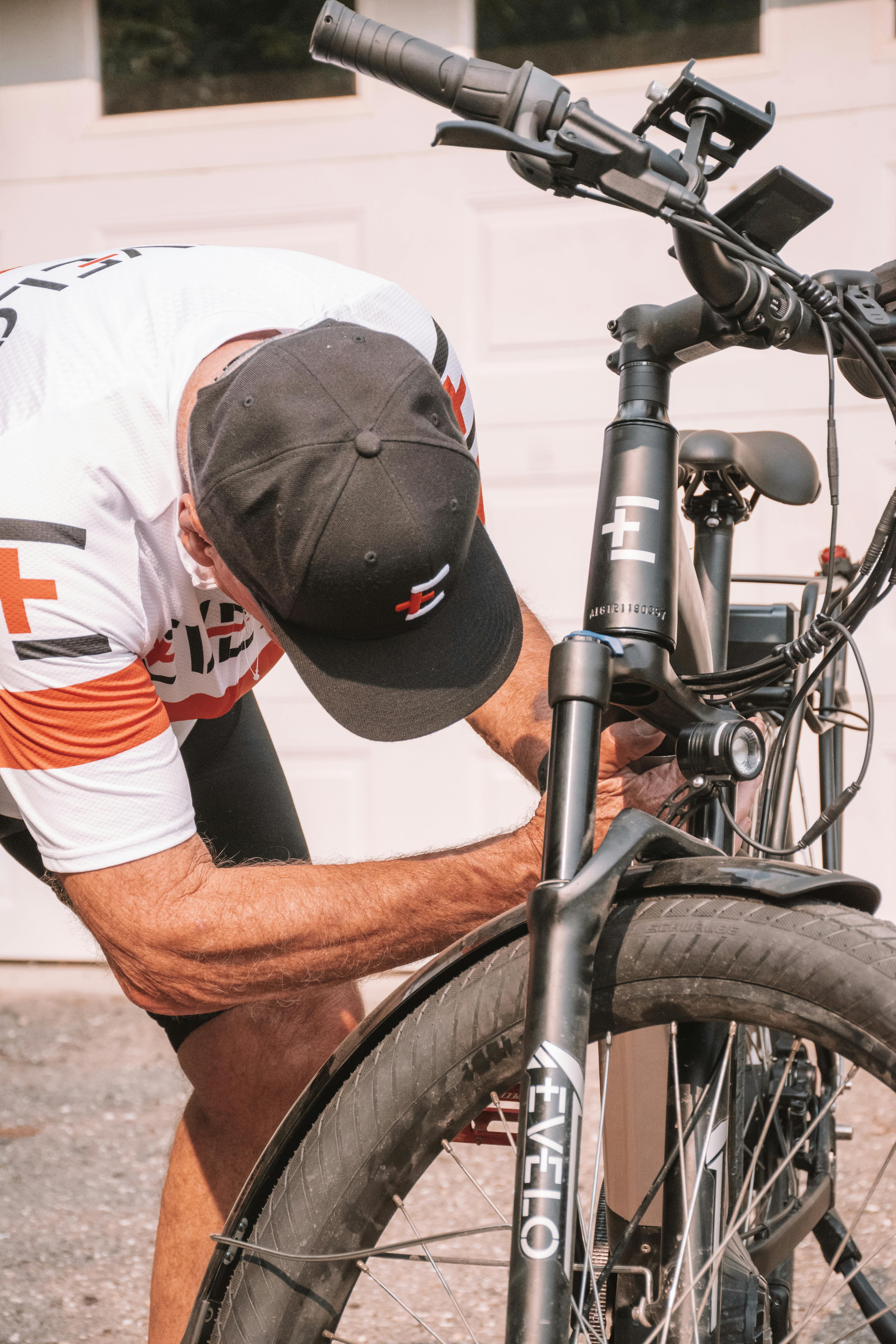 a man fixing his bike in front of a garage