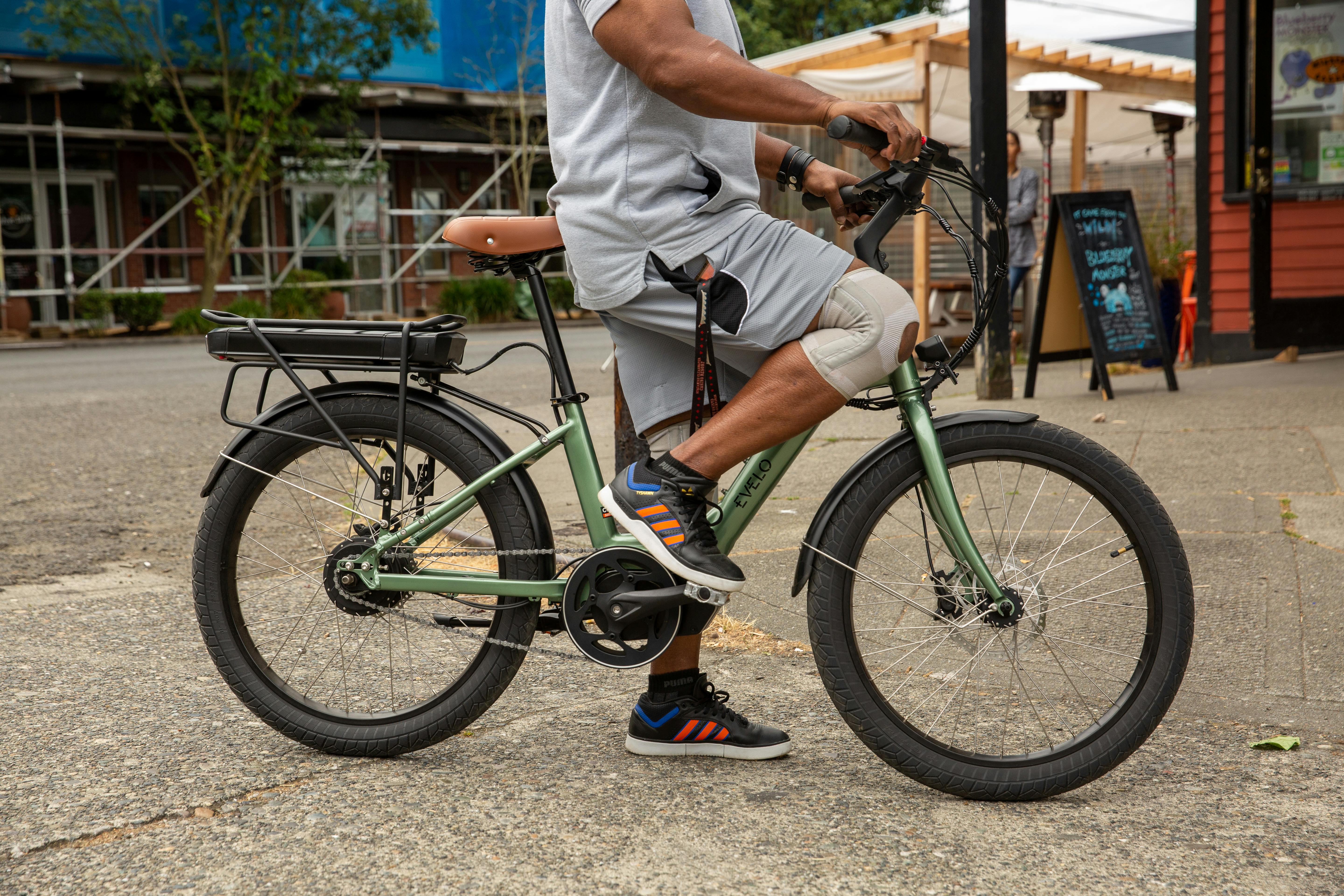 a man riding a bike on the sidewalk