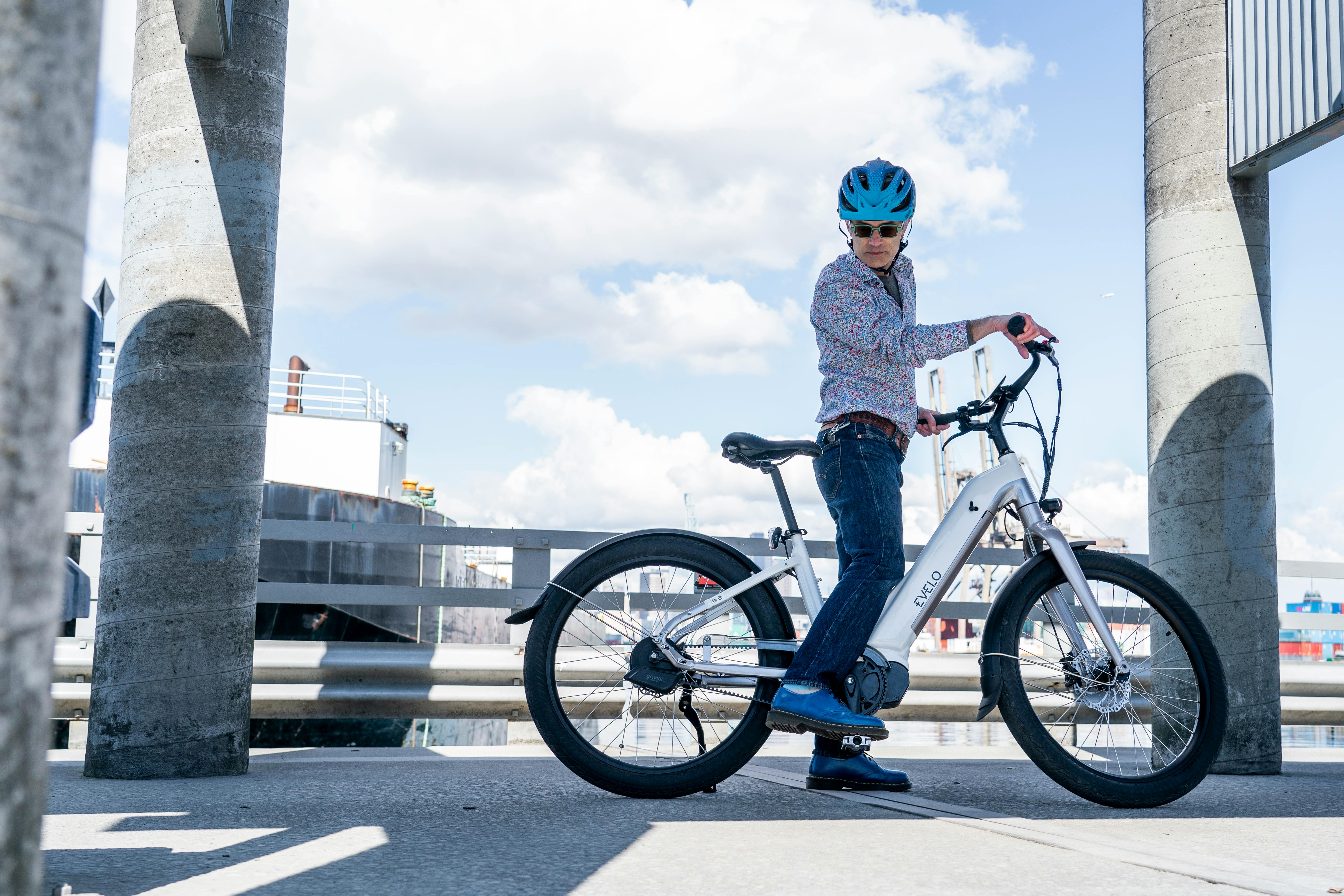 a person riding a bike near a bridge