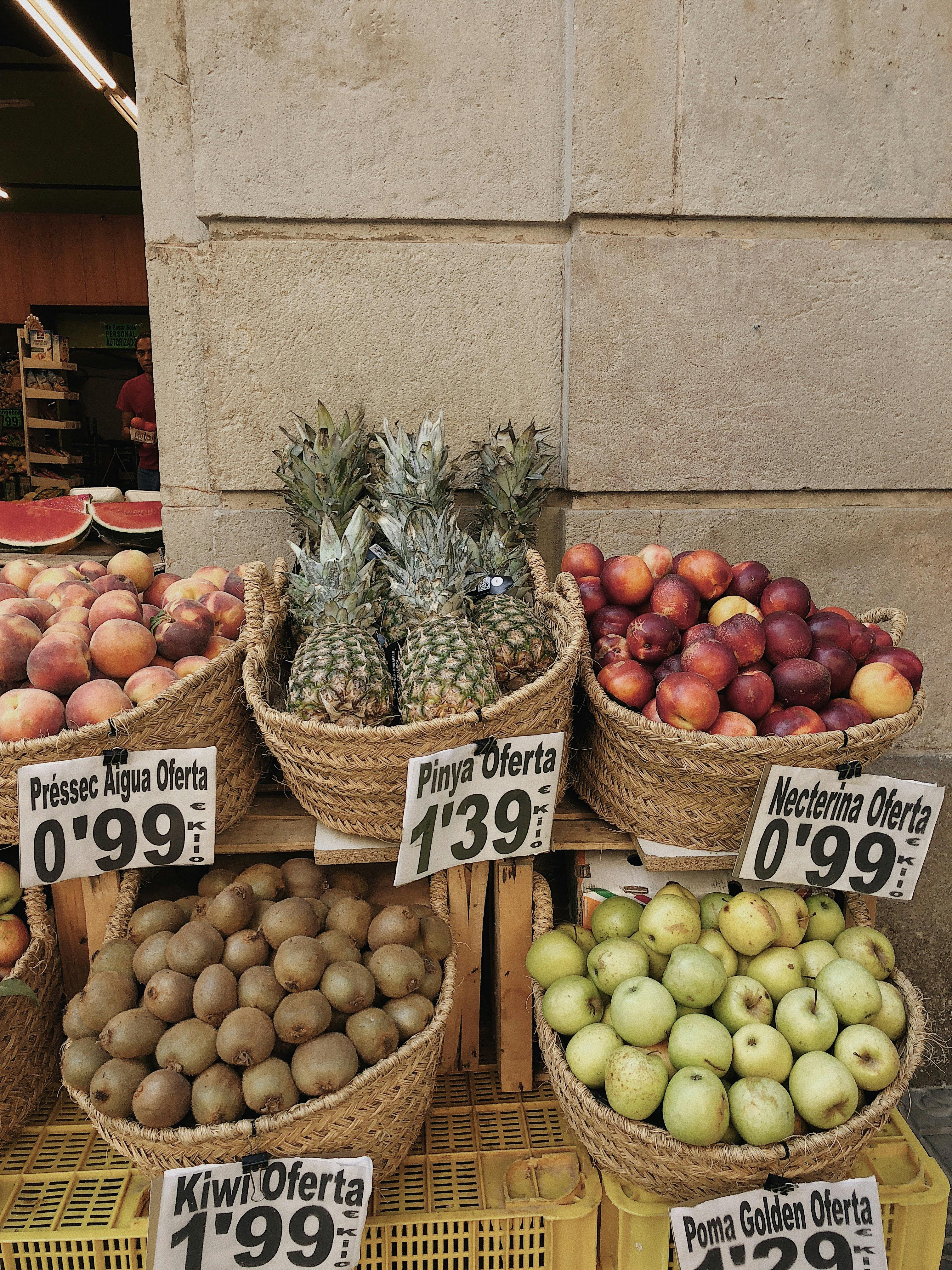 baskets of fruits near brown concrete wall