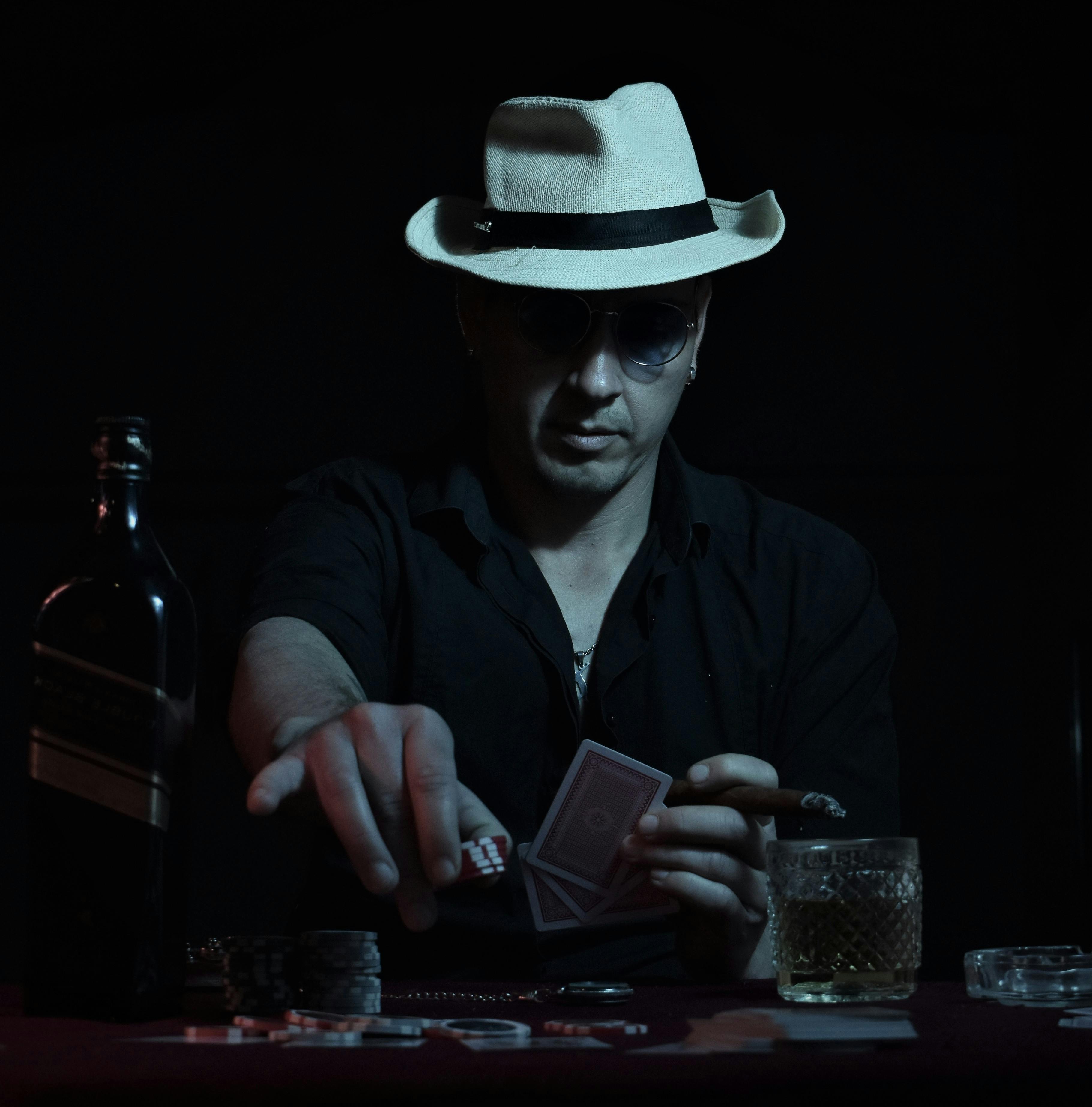 man in hat playing poker