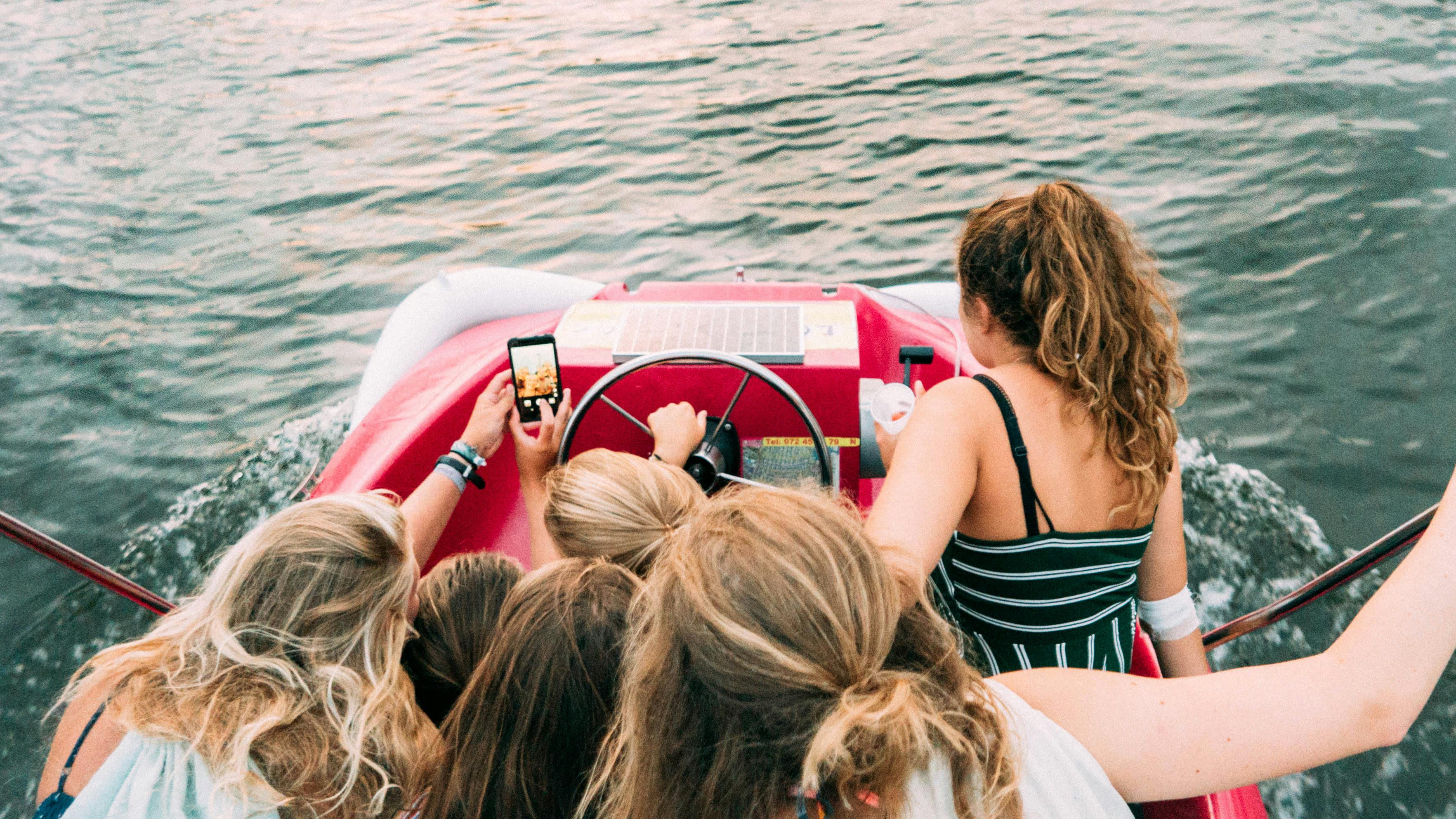 group of people riding red boat