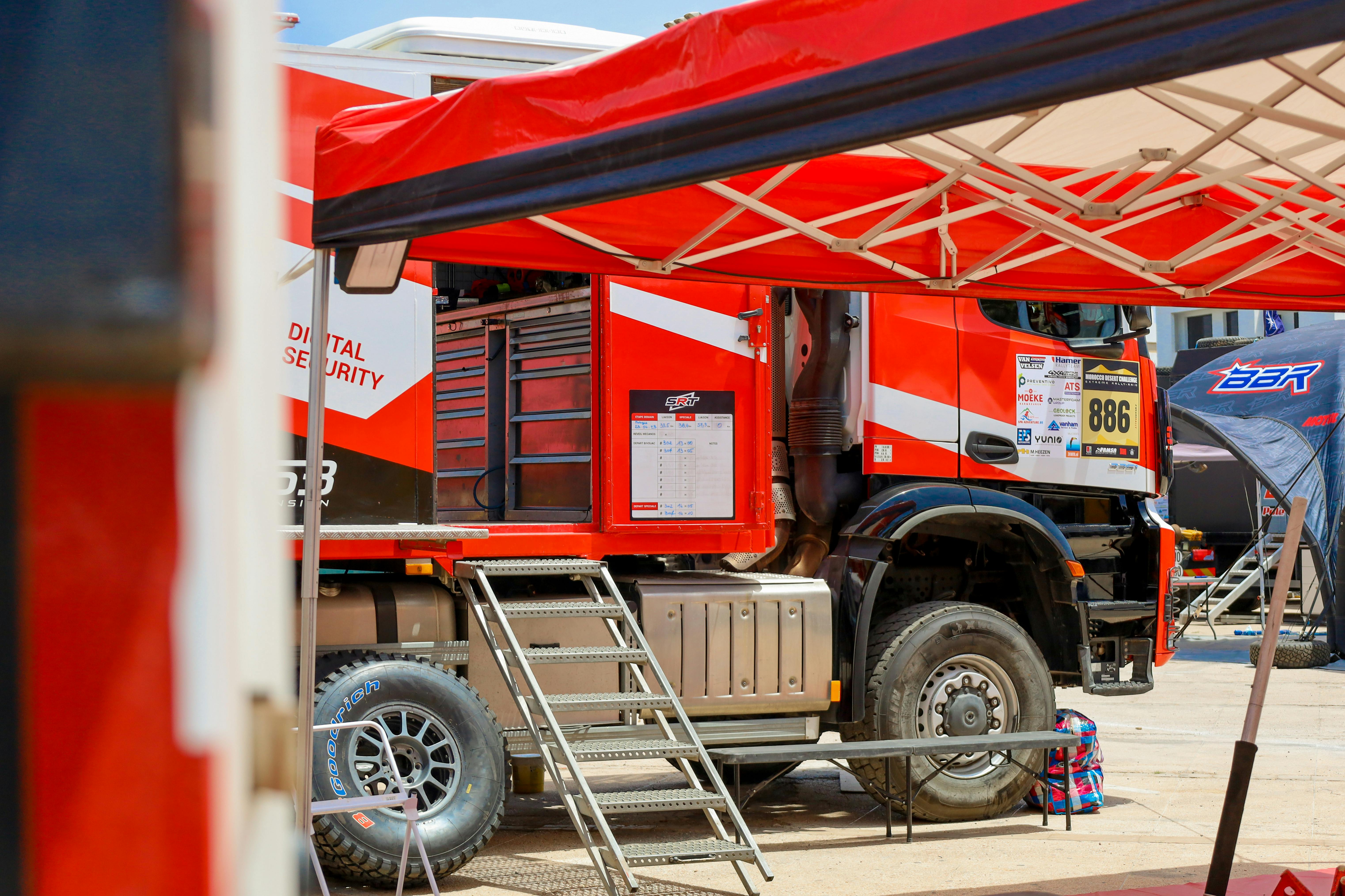 red mechanic rally truck in the street