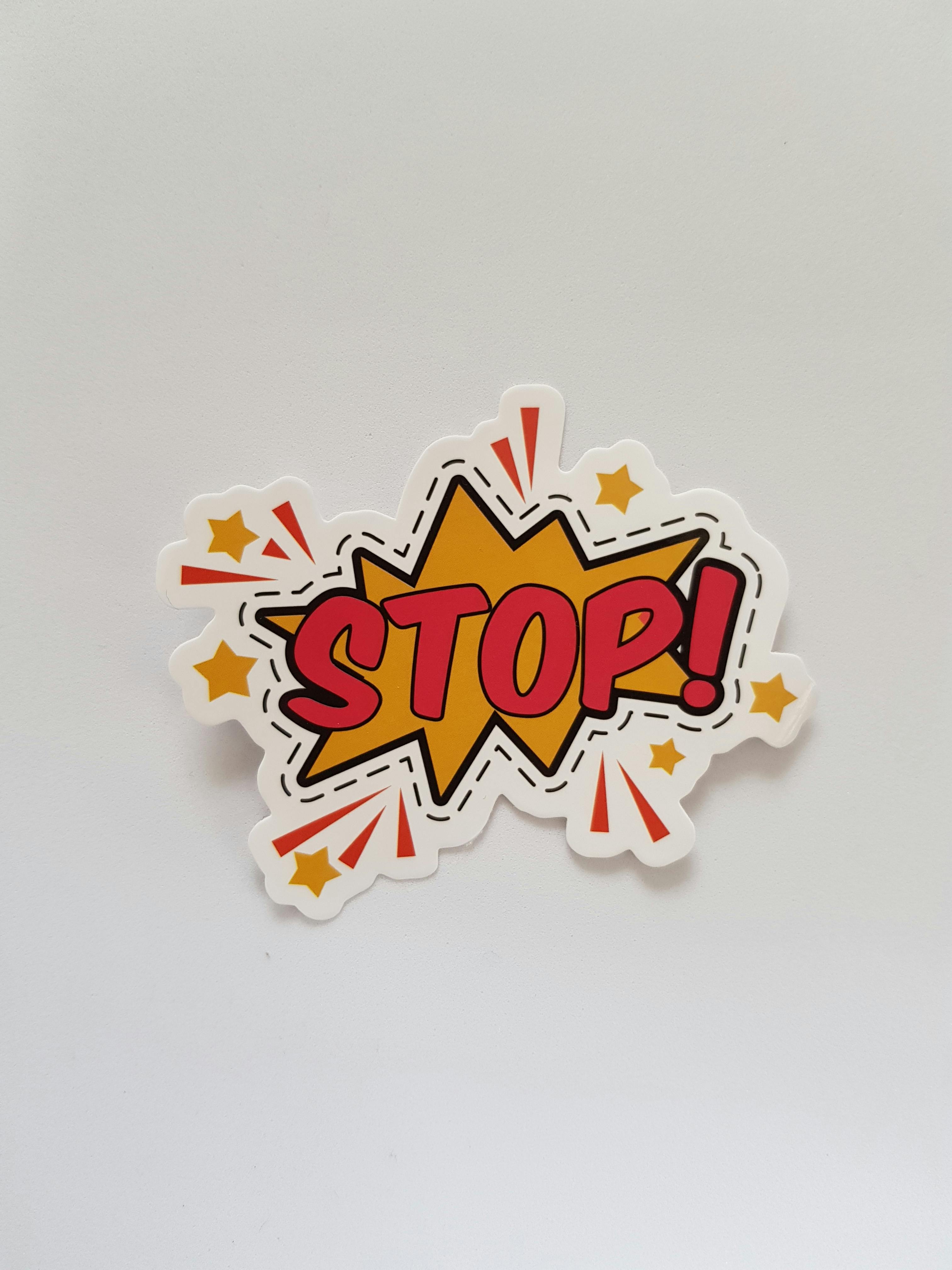 red and yellow stop sticker