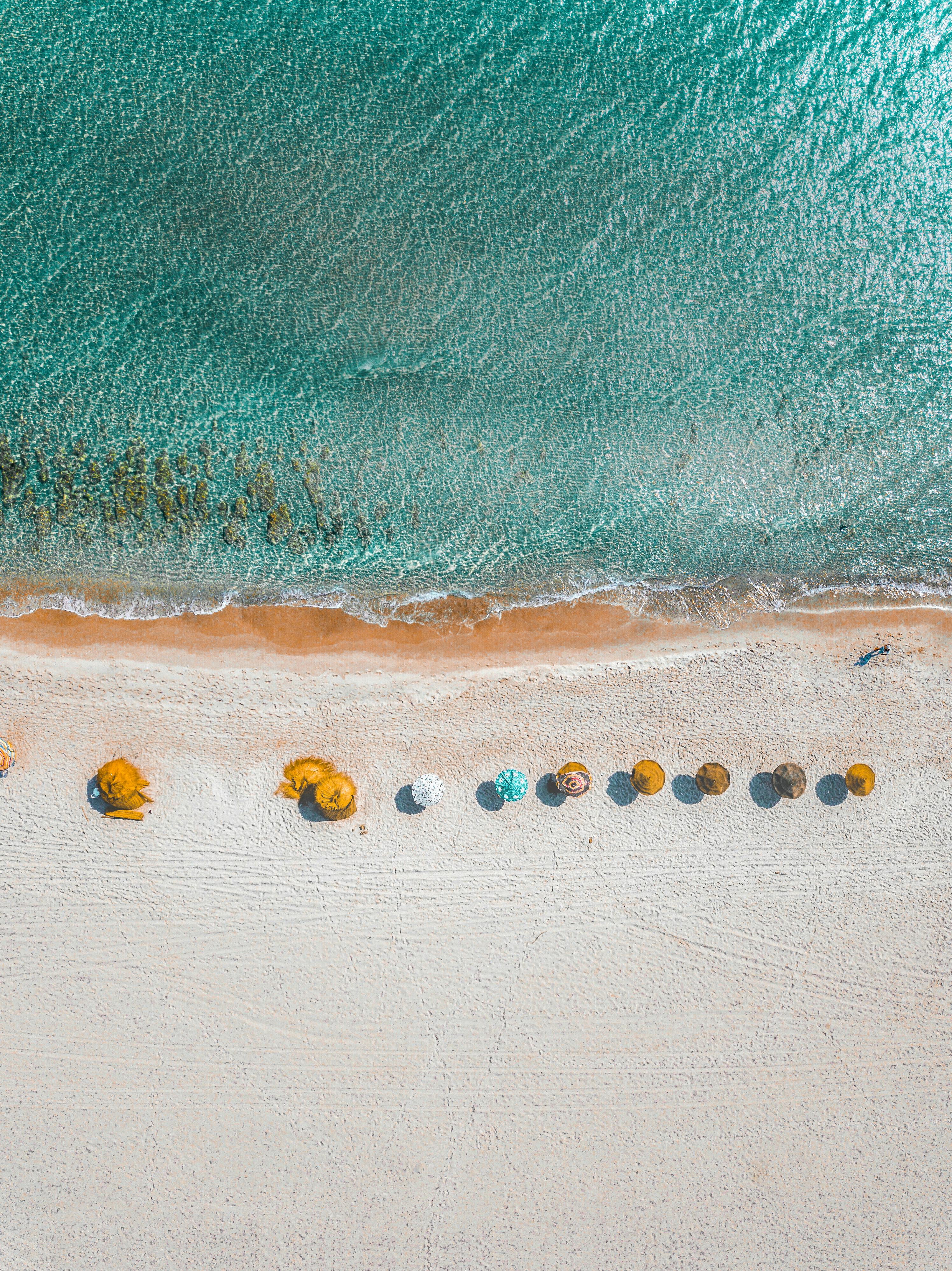 aerial view photography of umbrellas on shore