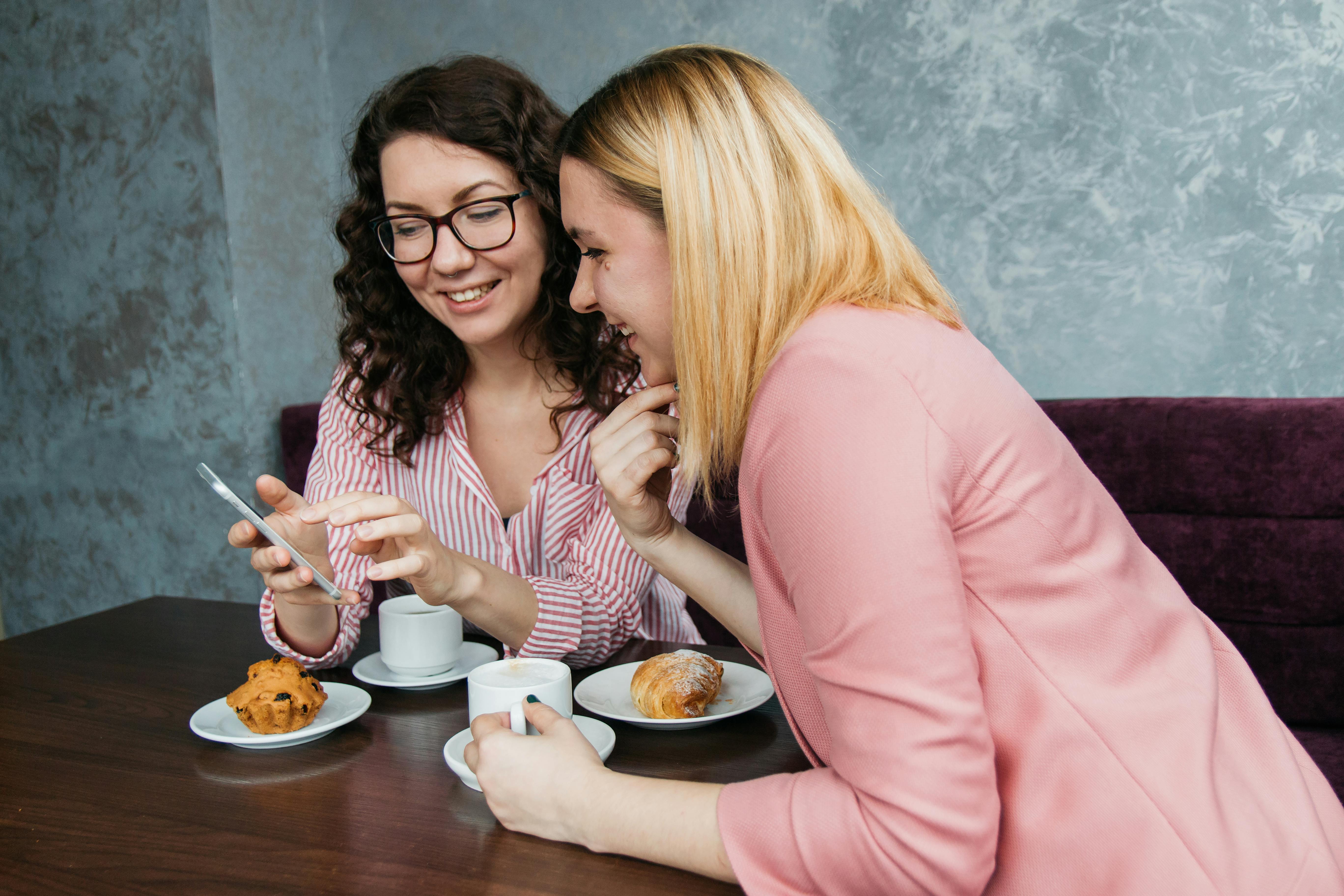 two women looking on smartphone