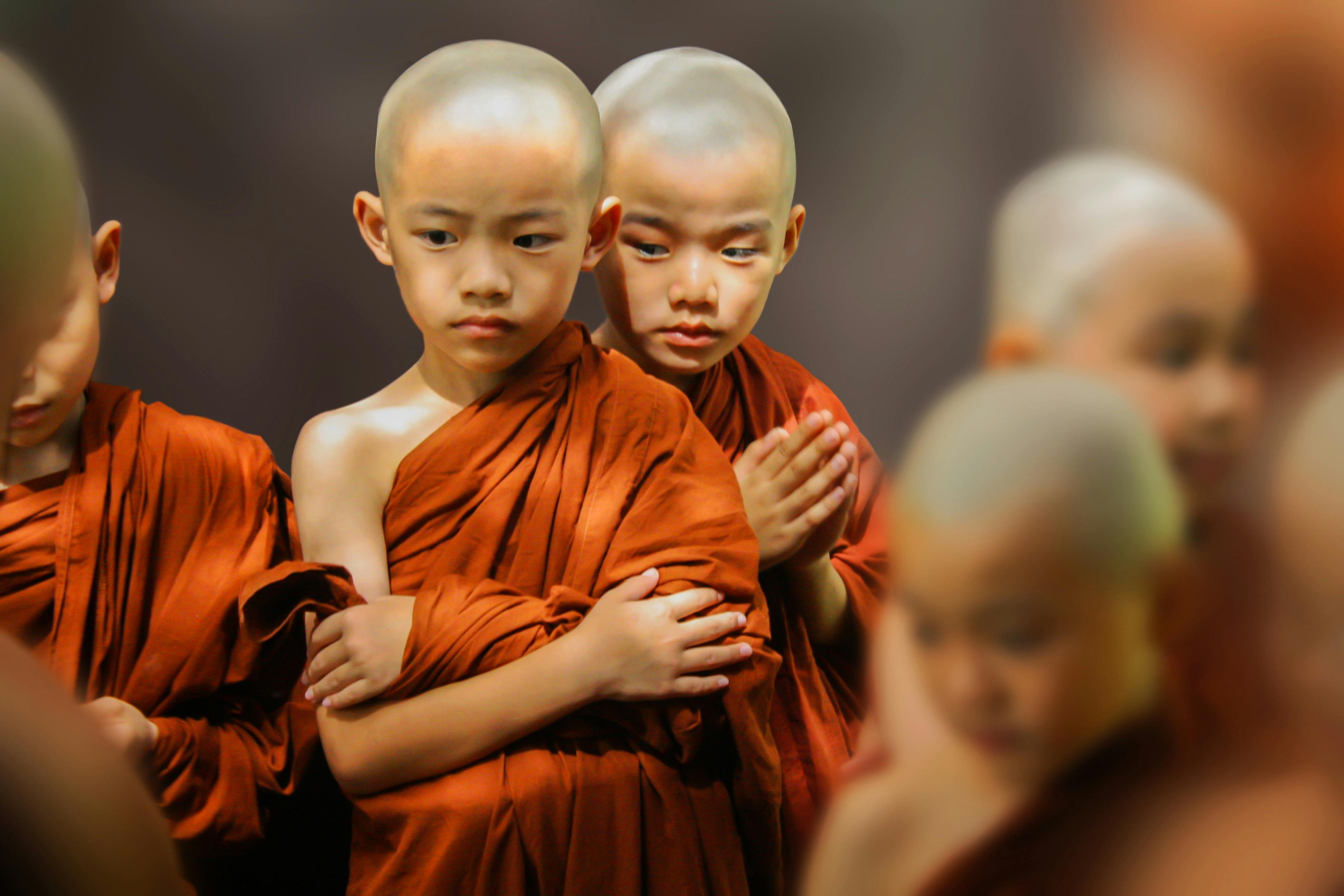 three boy in orange suits