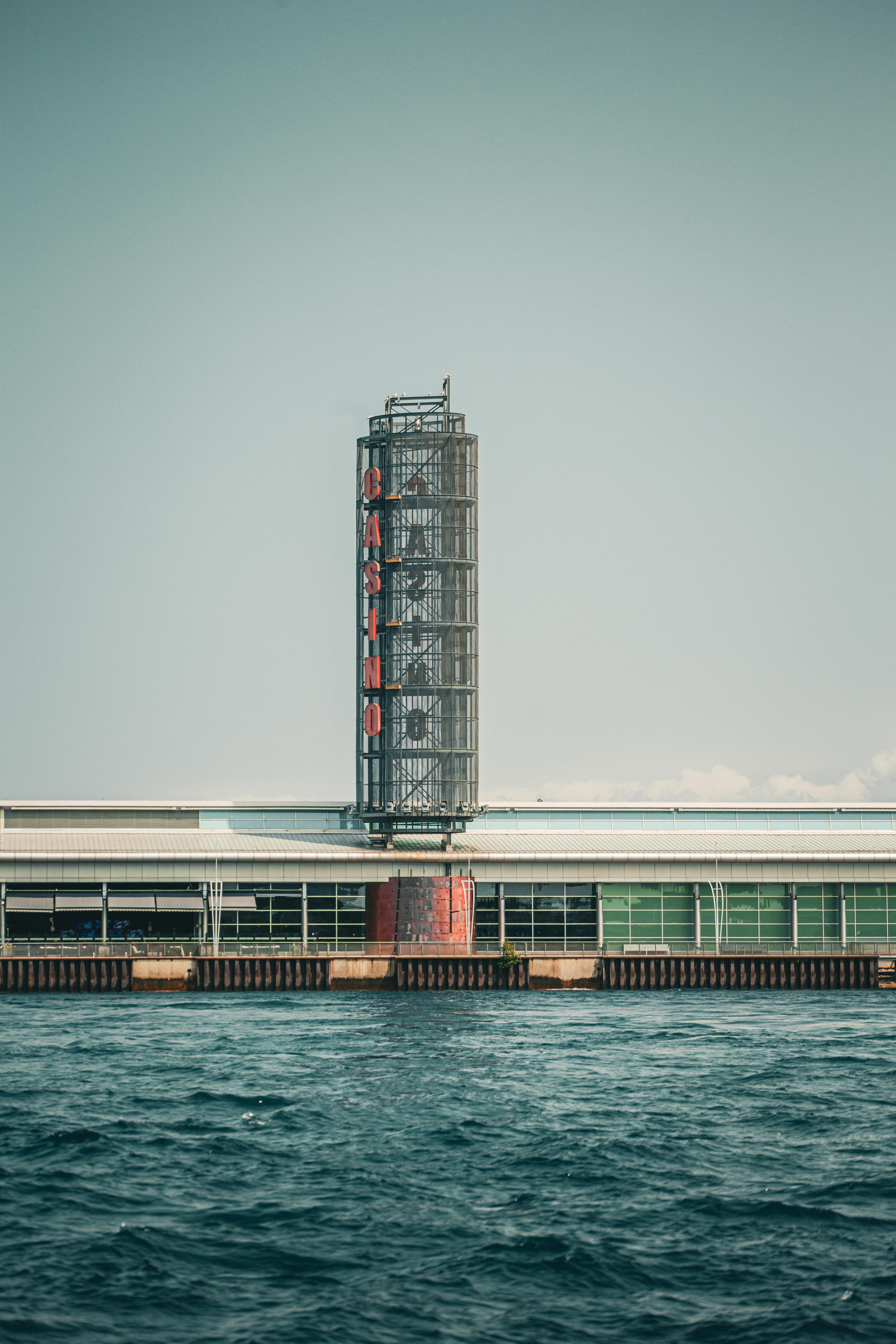 a large building with a clock on it sitting on the water