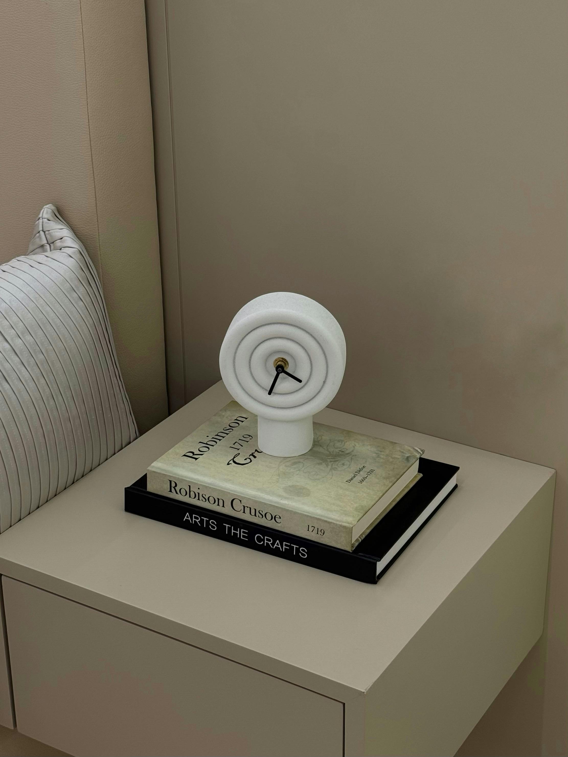 minimalist bedside table with modern clock