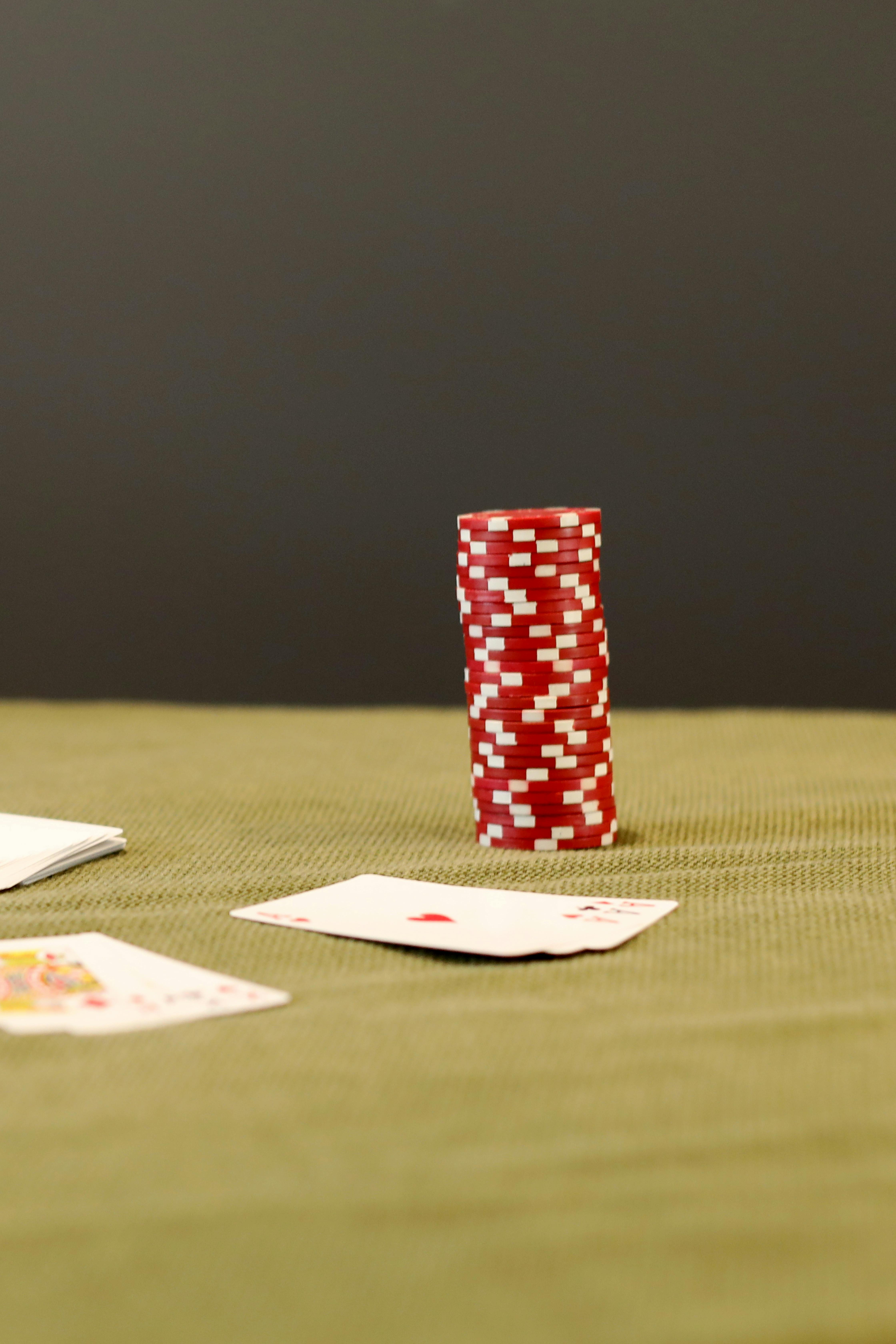 poker chips and playing cards on green table