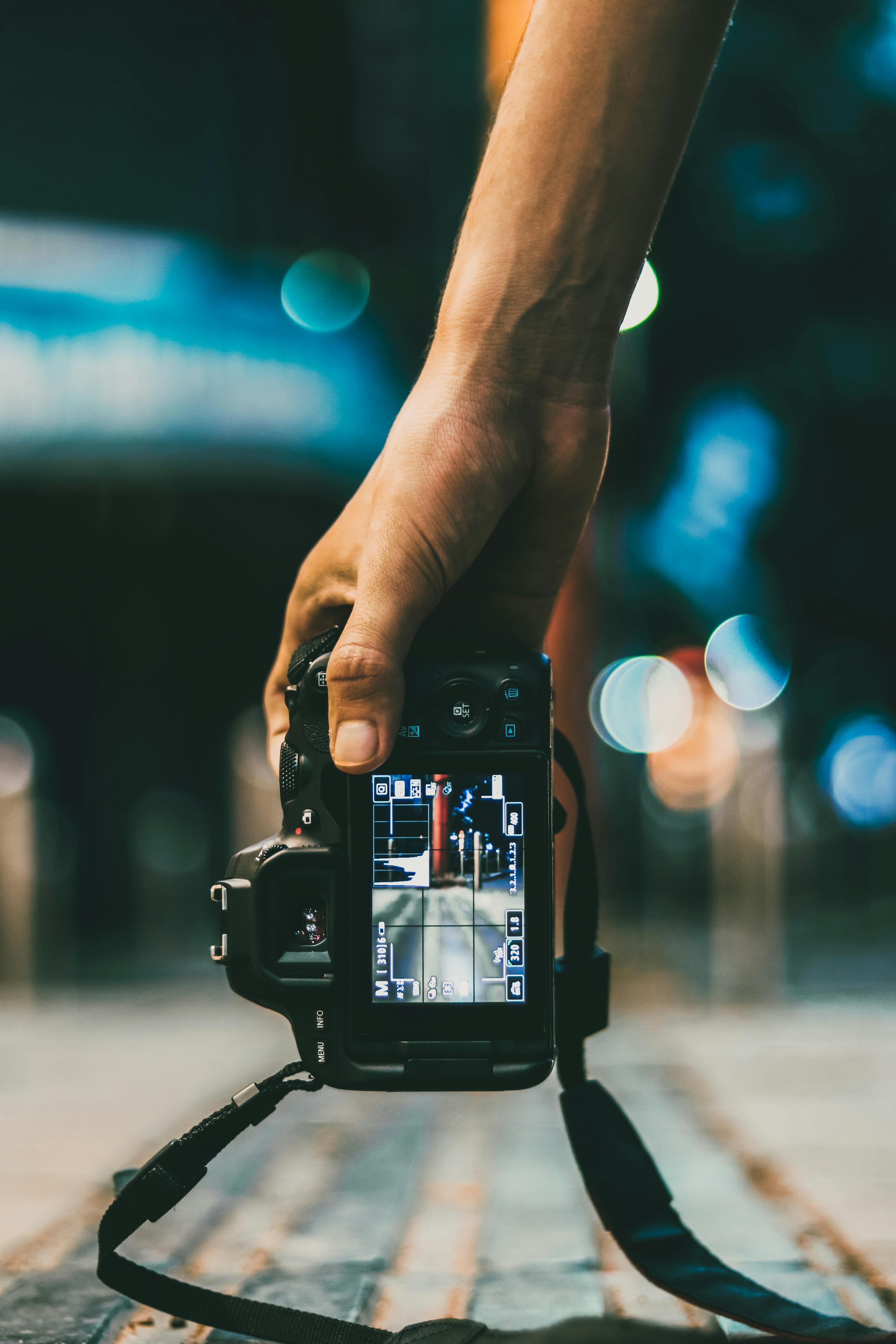 person holding dslr camera