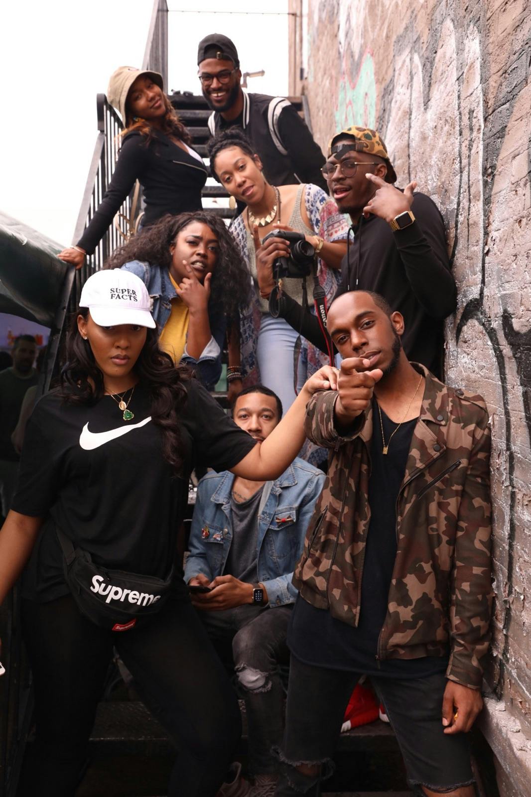 group of people standing on metal stairs