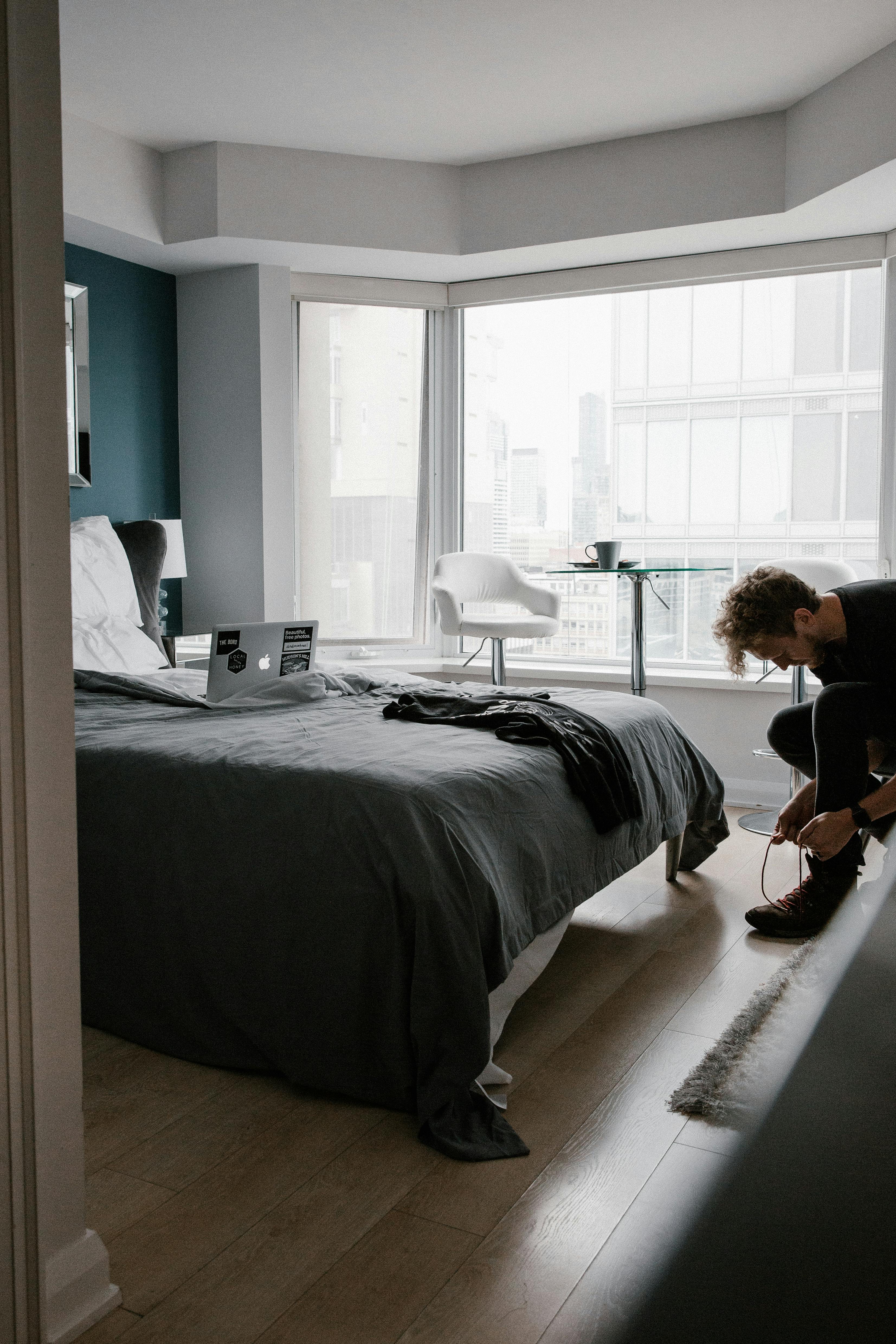 man standing near bed