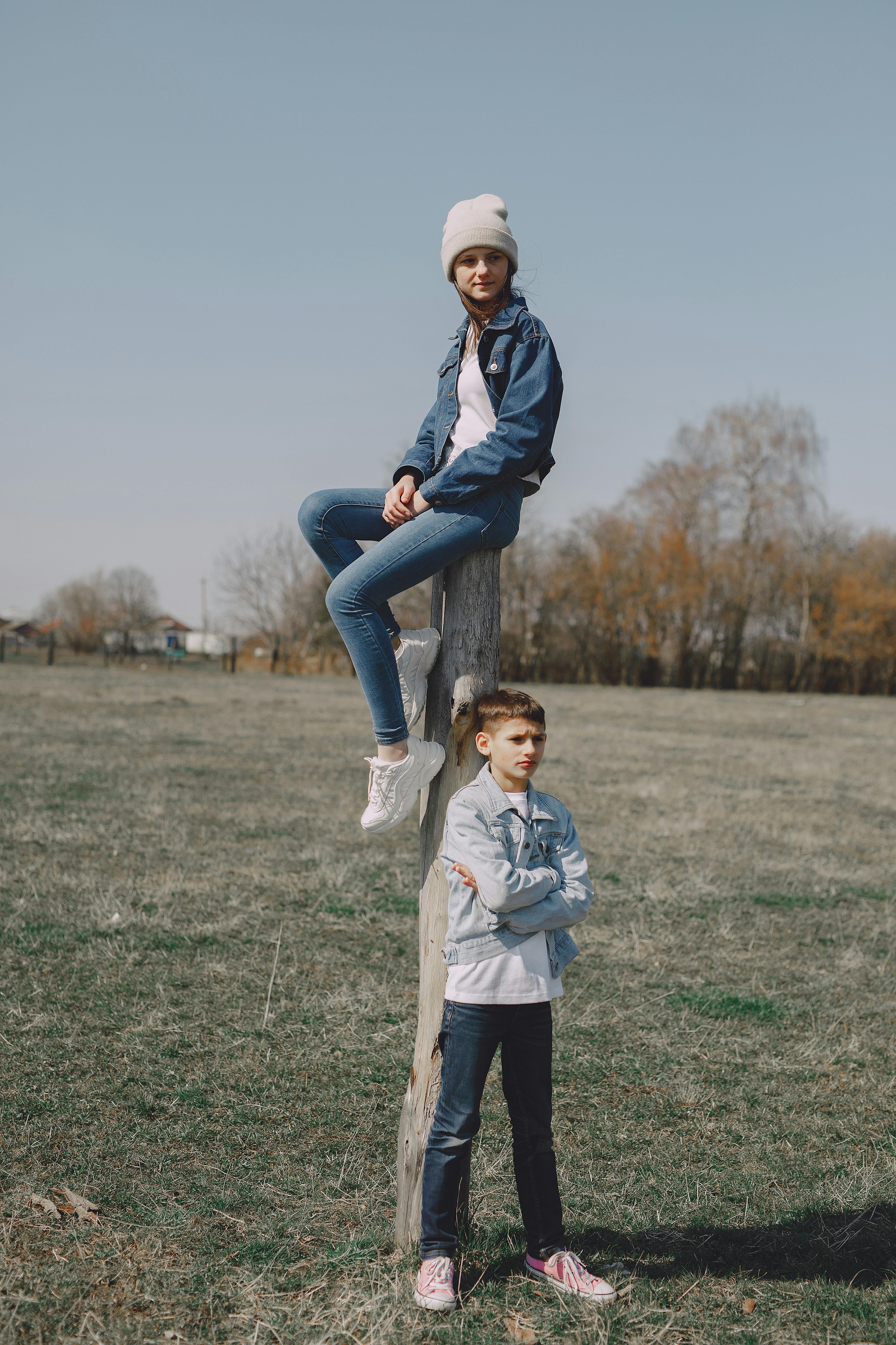 serious young friends walking on meadow