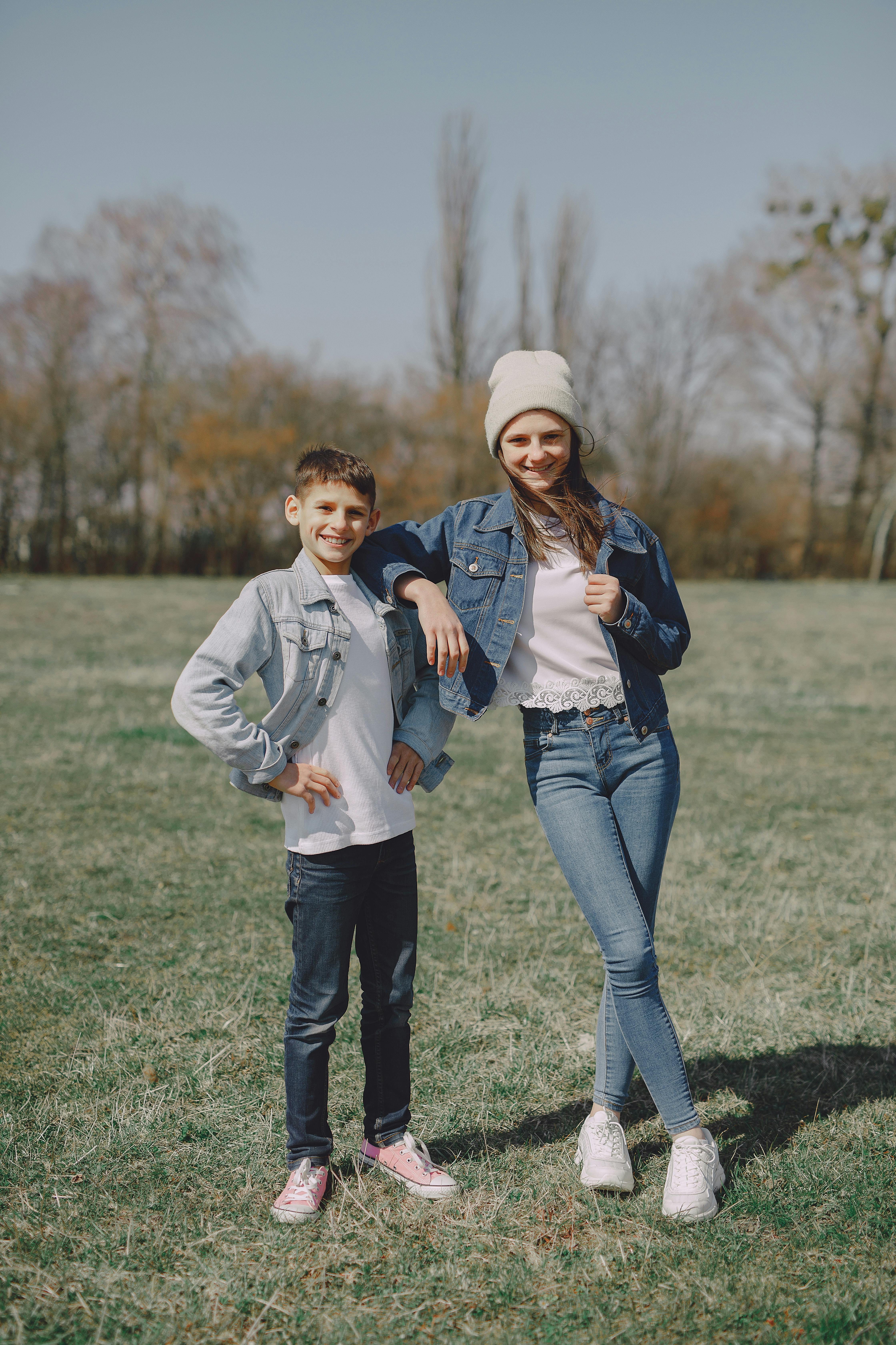 cheerful young friends standing in park