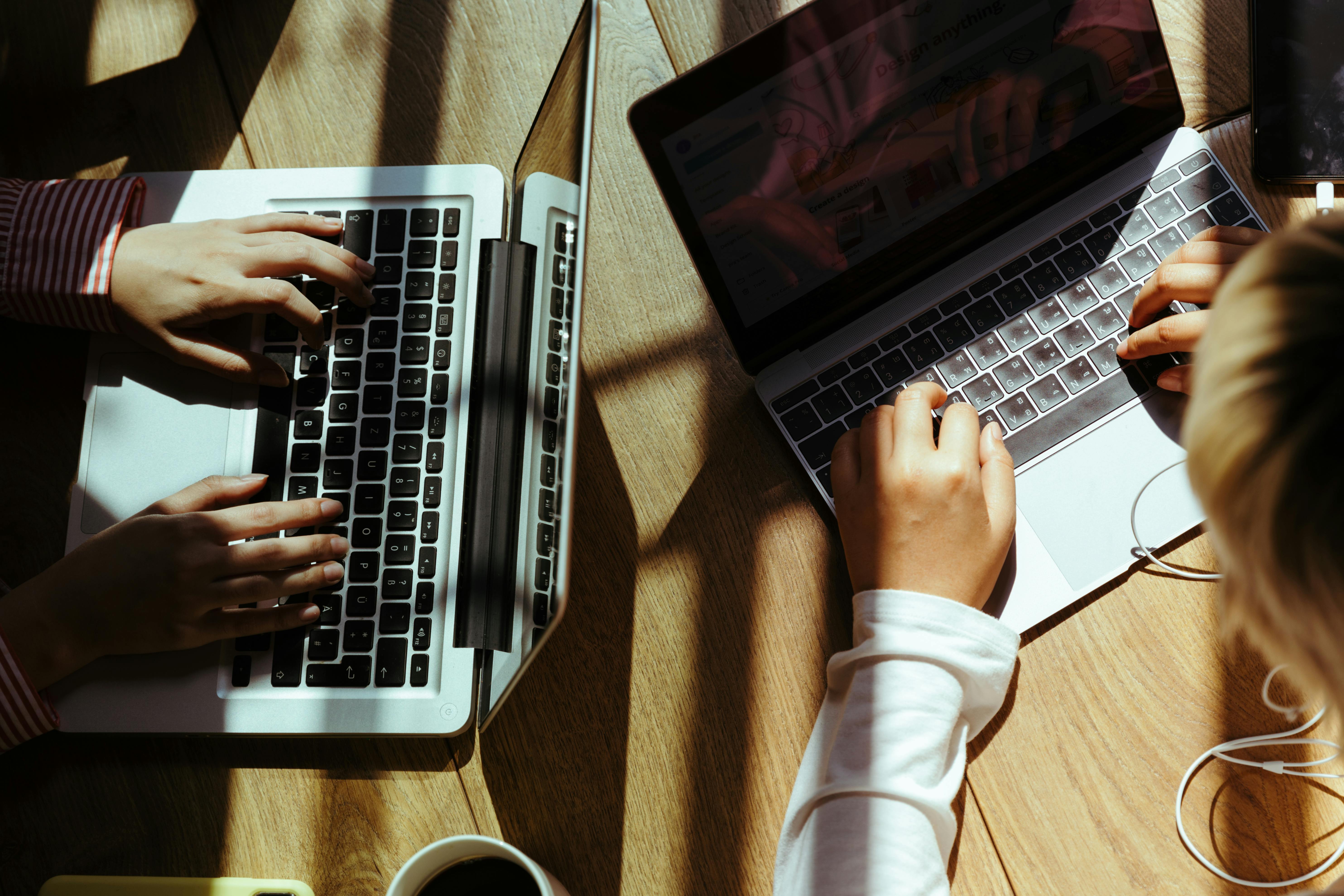 crop women typing on laptop keyboard