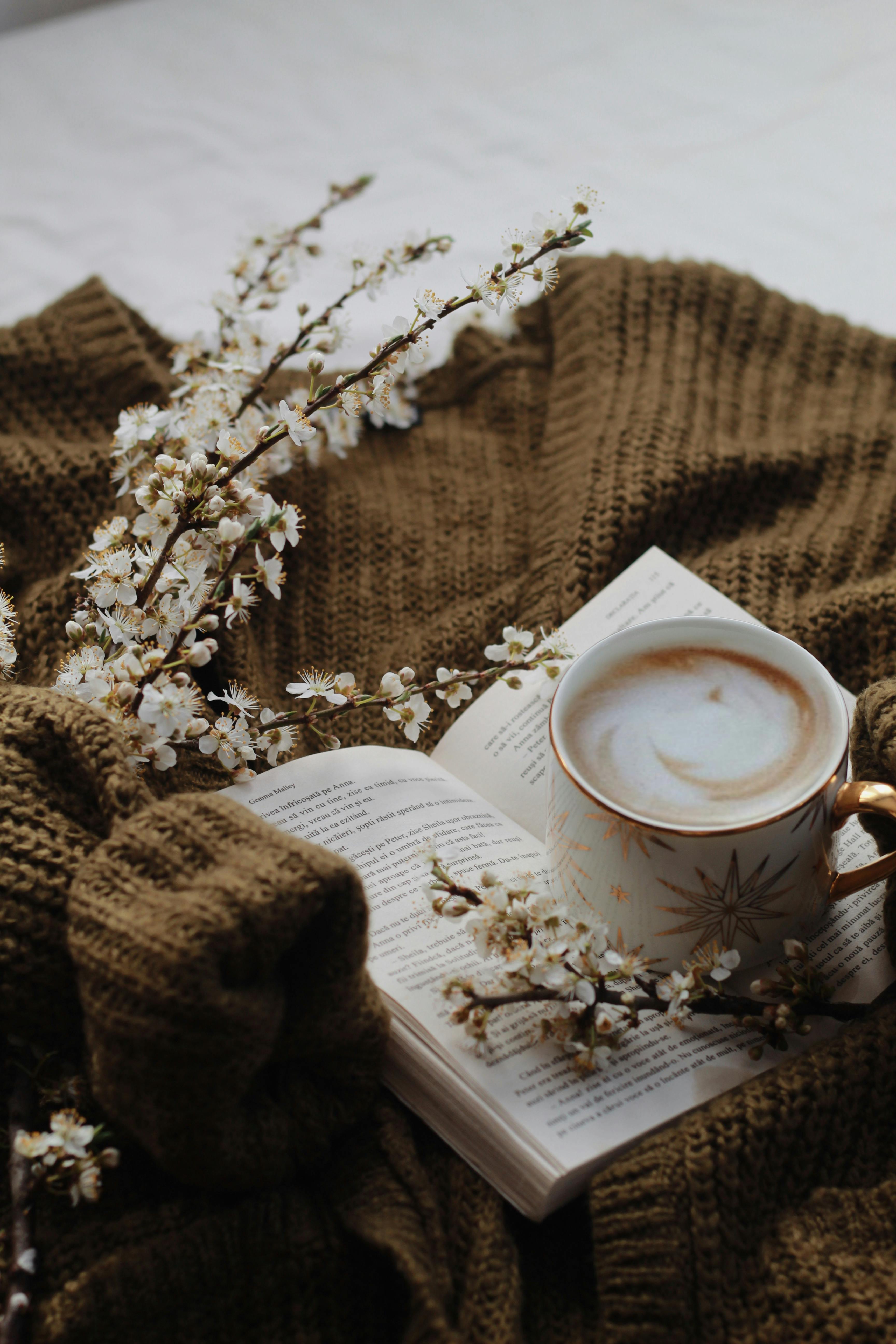 cup of coffee on an opened book