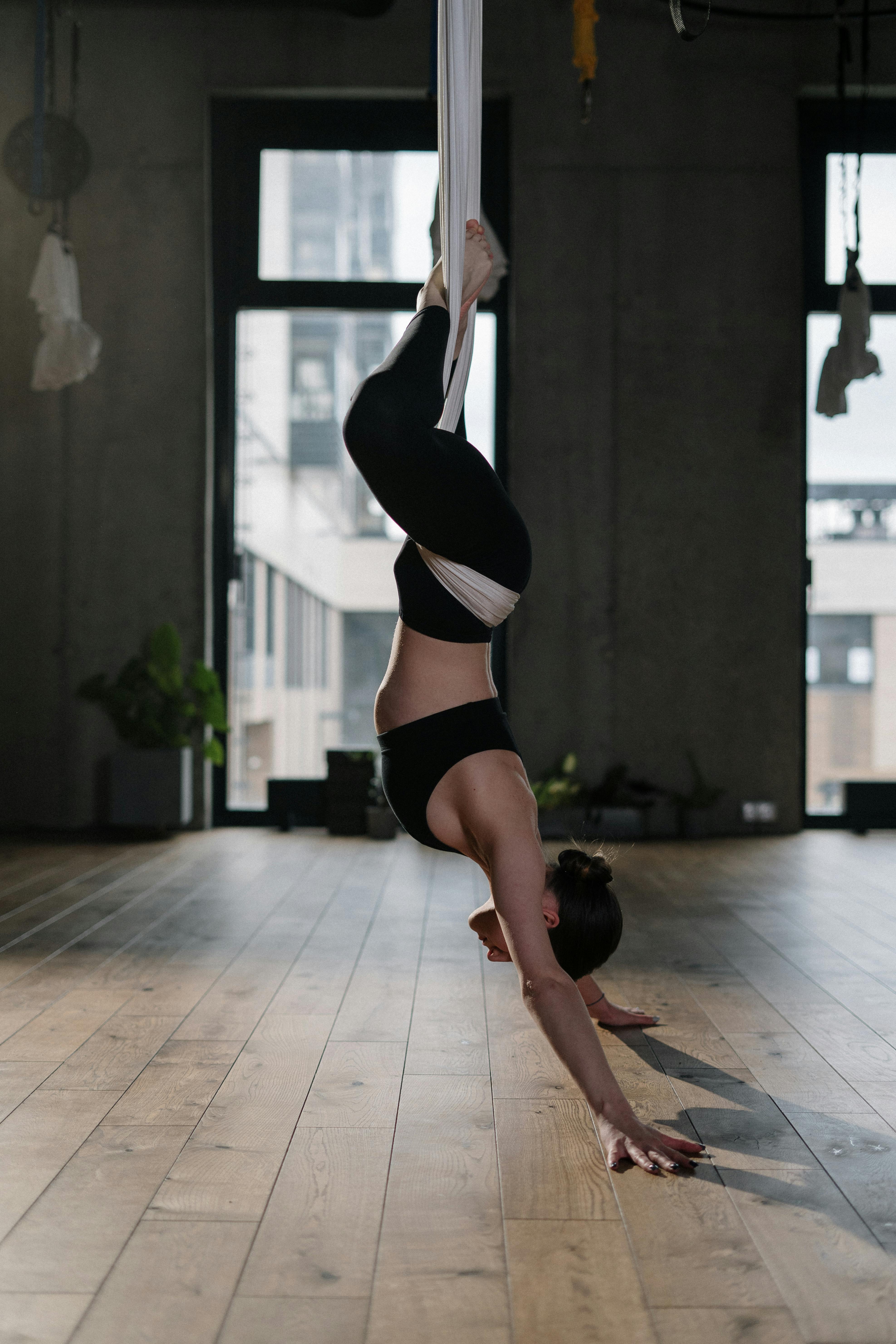 woman in black sports bra and black panty bending her body