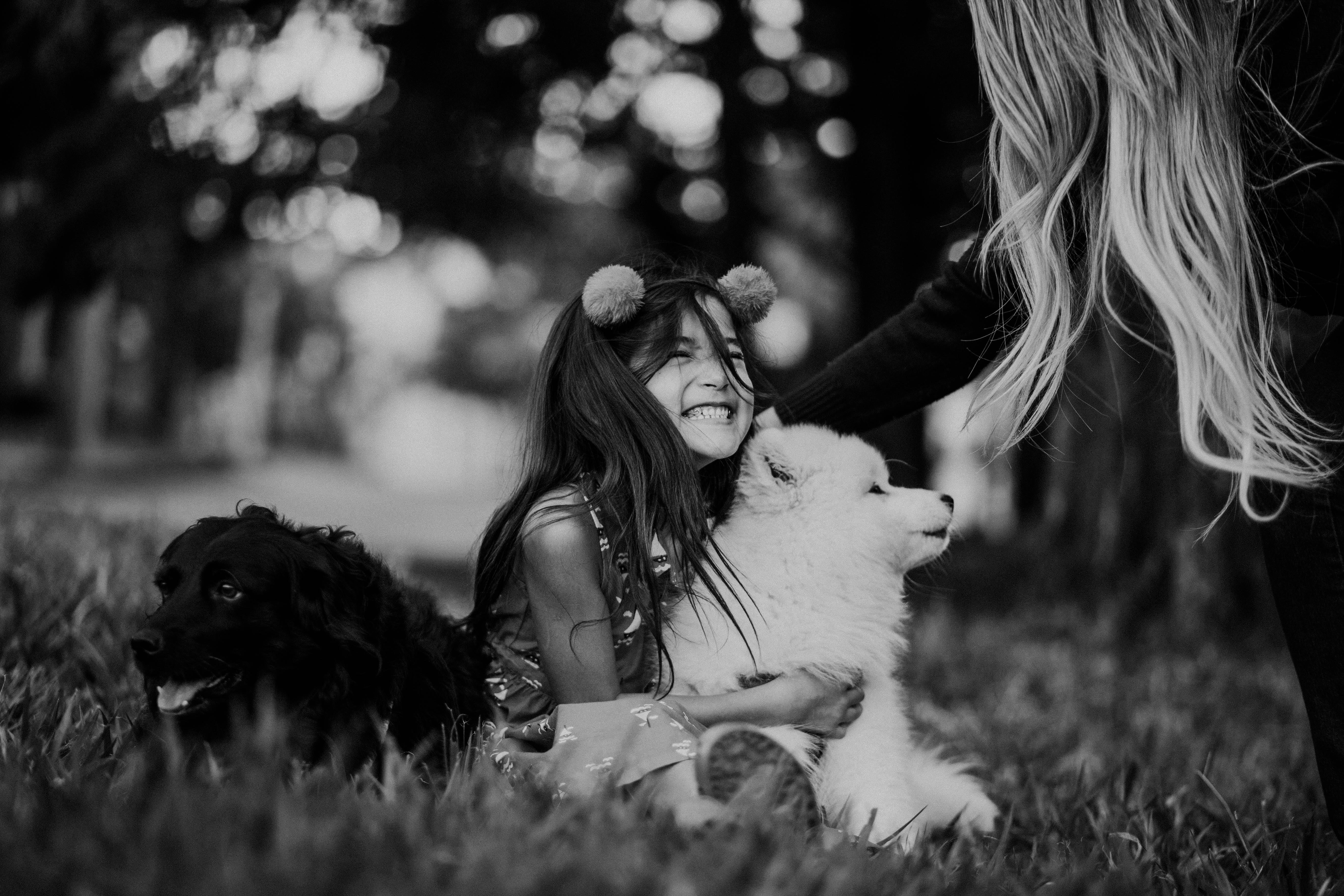 content kid embracing dog on lawn