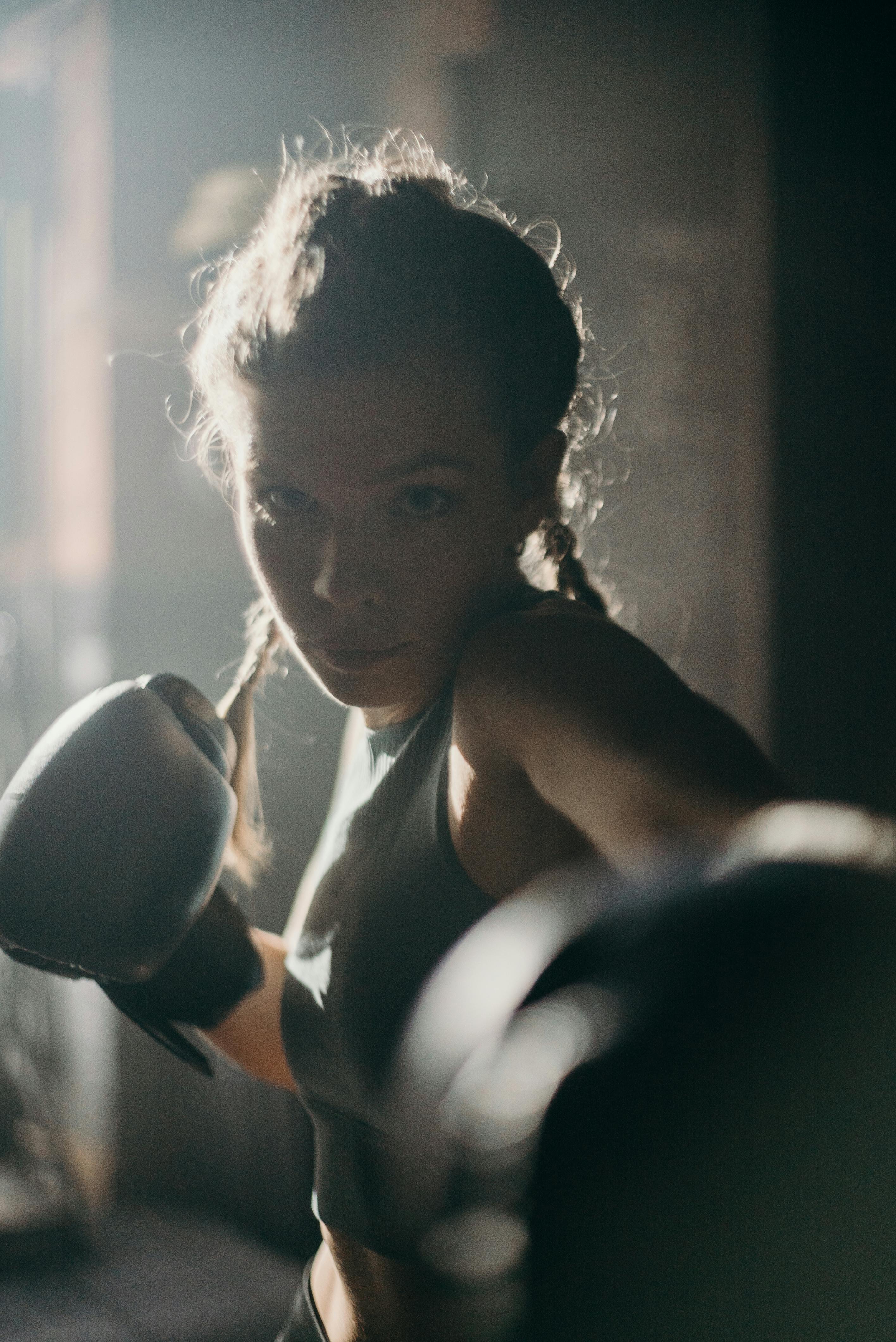 woman in black brassiere holding black kettle bell