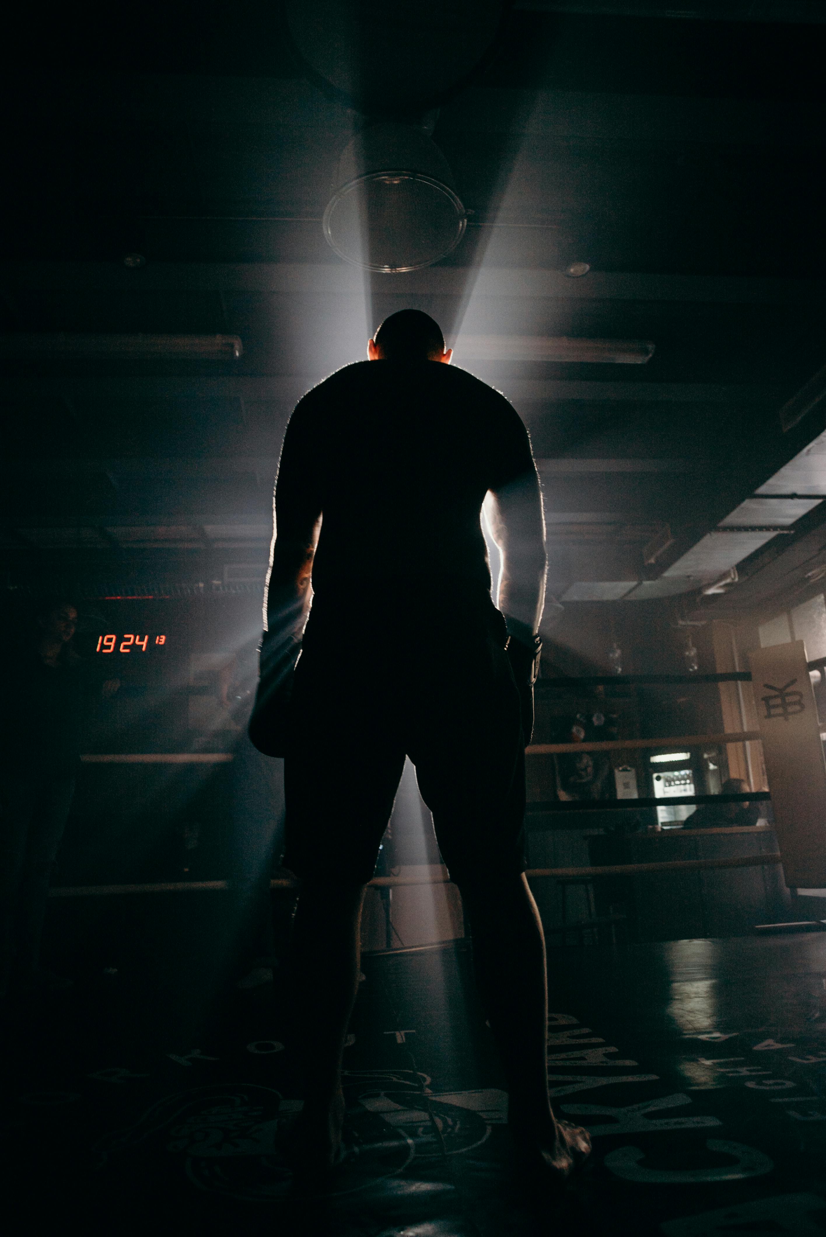 man in black shirt and pants standing on the floor