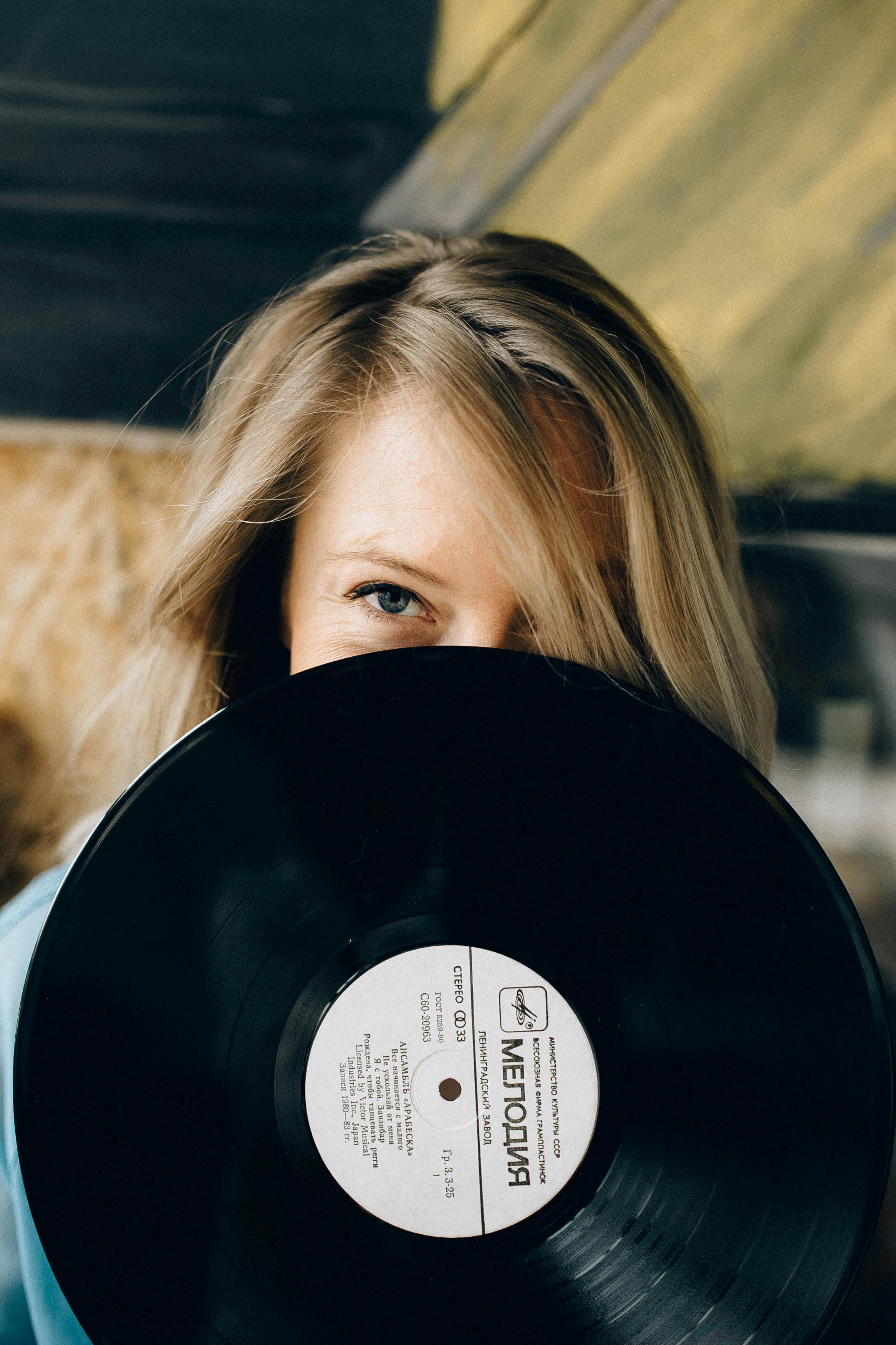 a woman holding a vinyl record