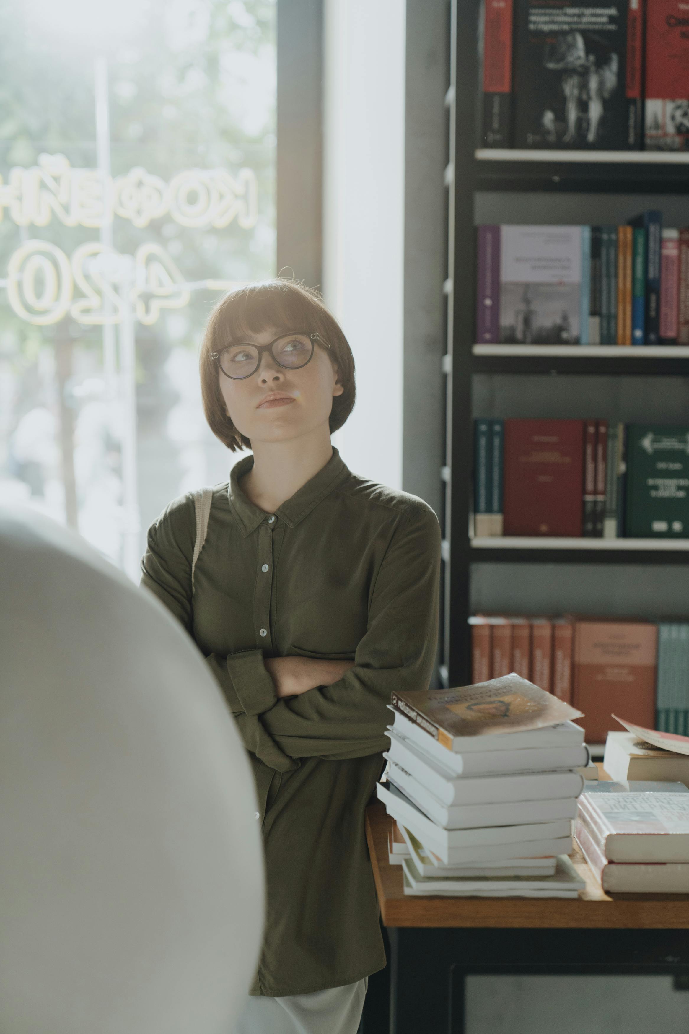 woman in green long sleeve shirt wearing eyeglasses