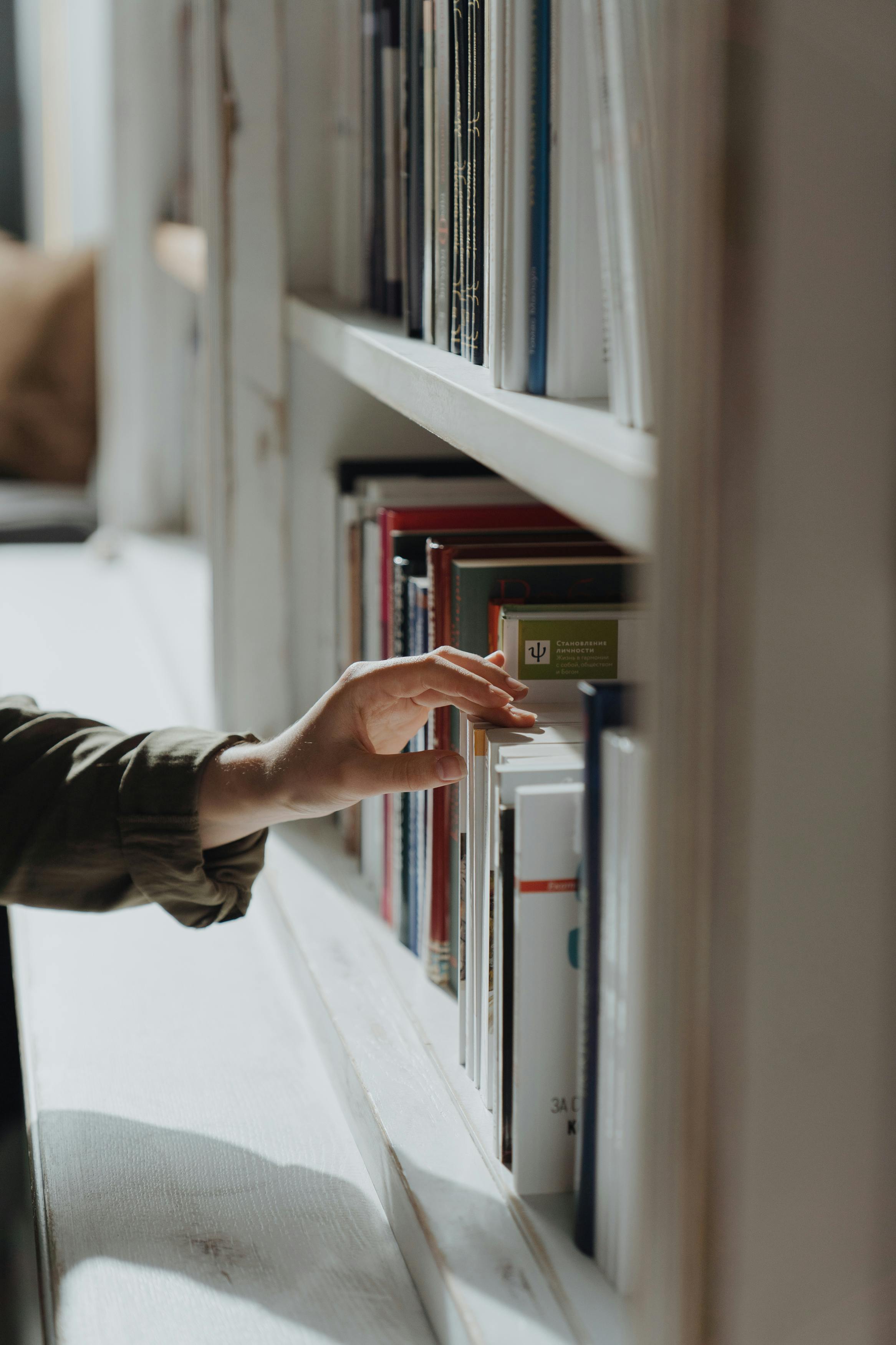 person in black long sleeve shirt holding book