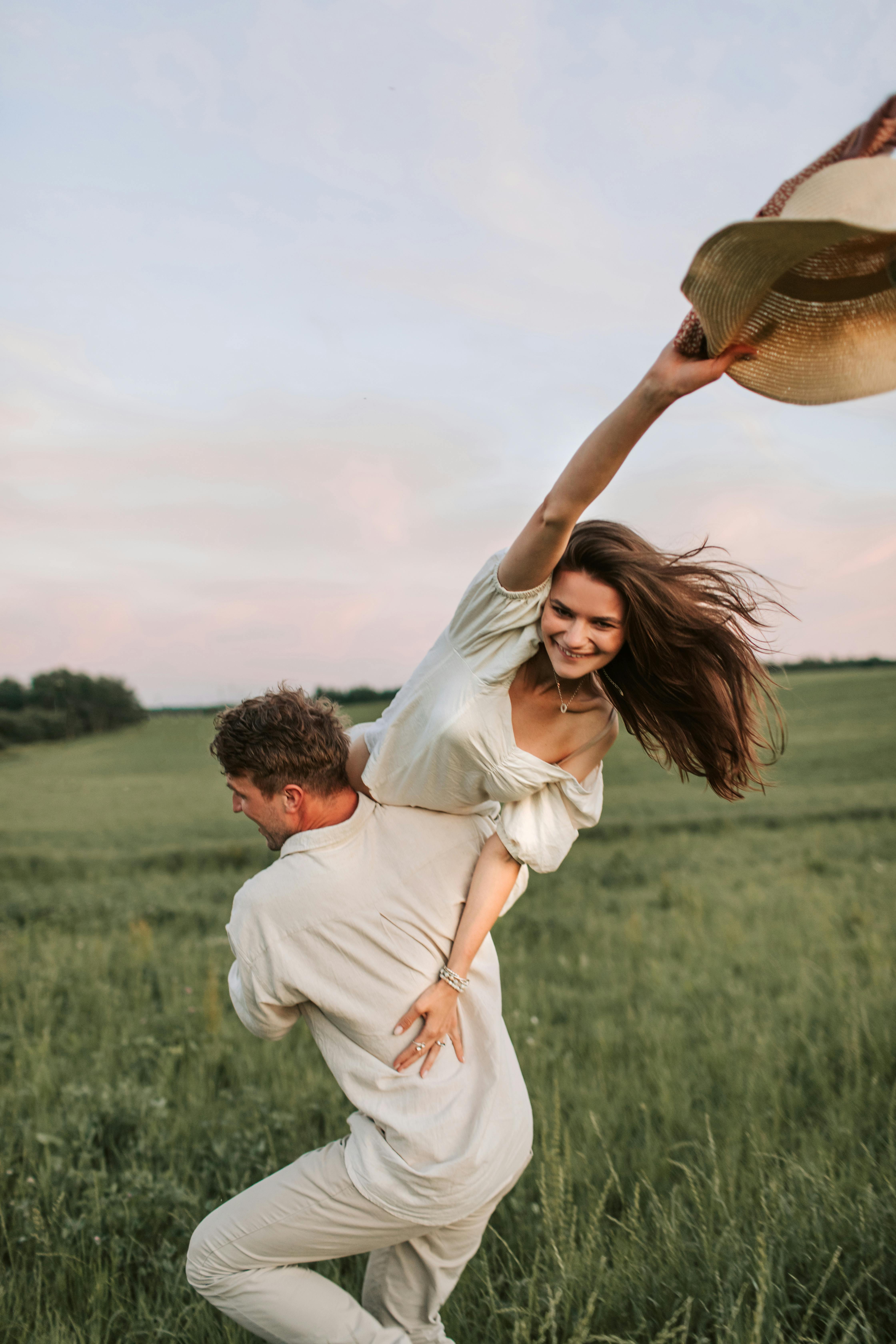 man carrying woman