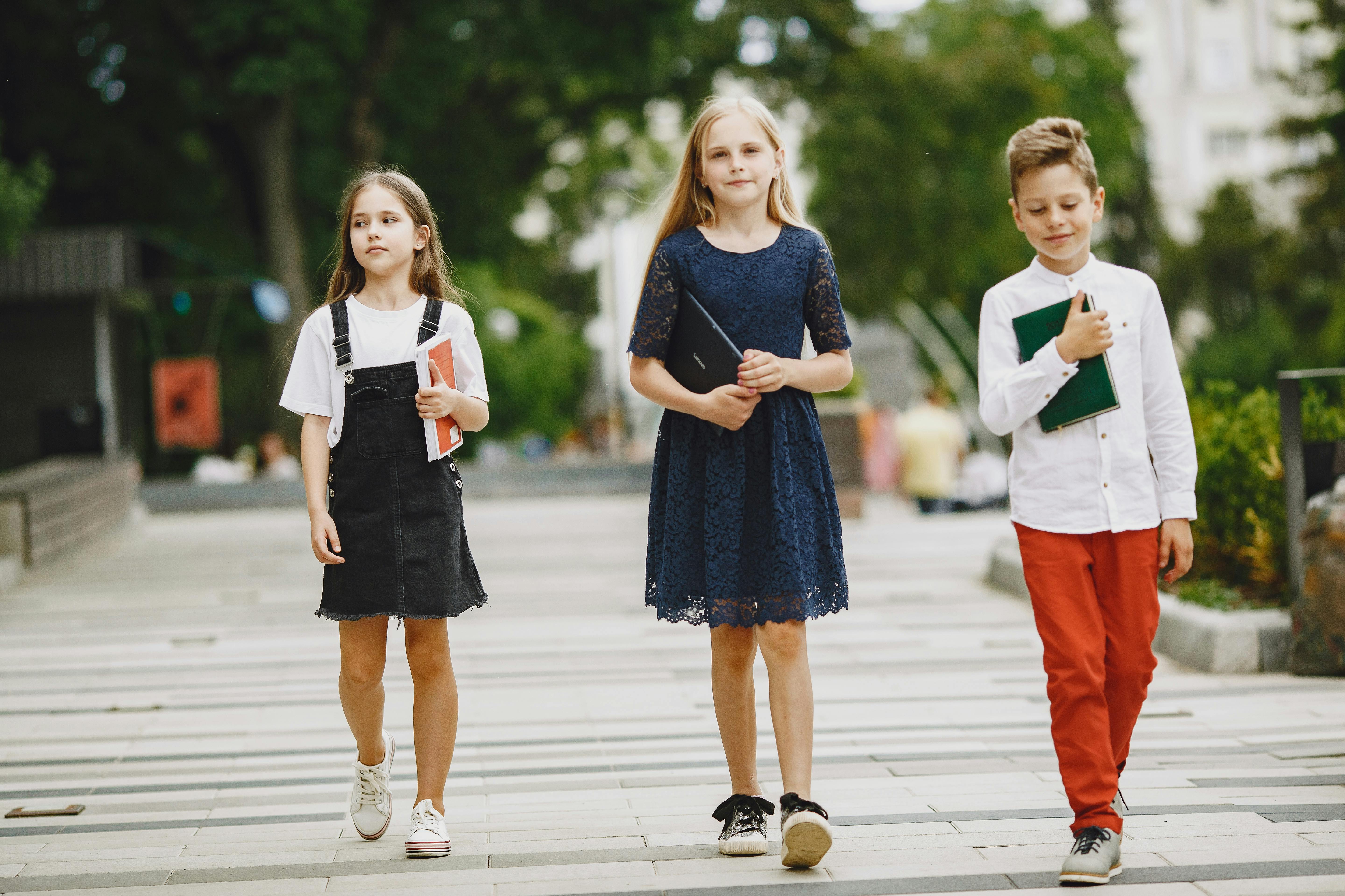 photo of kids walking with their books