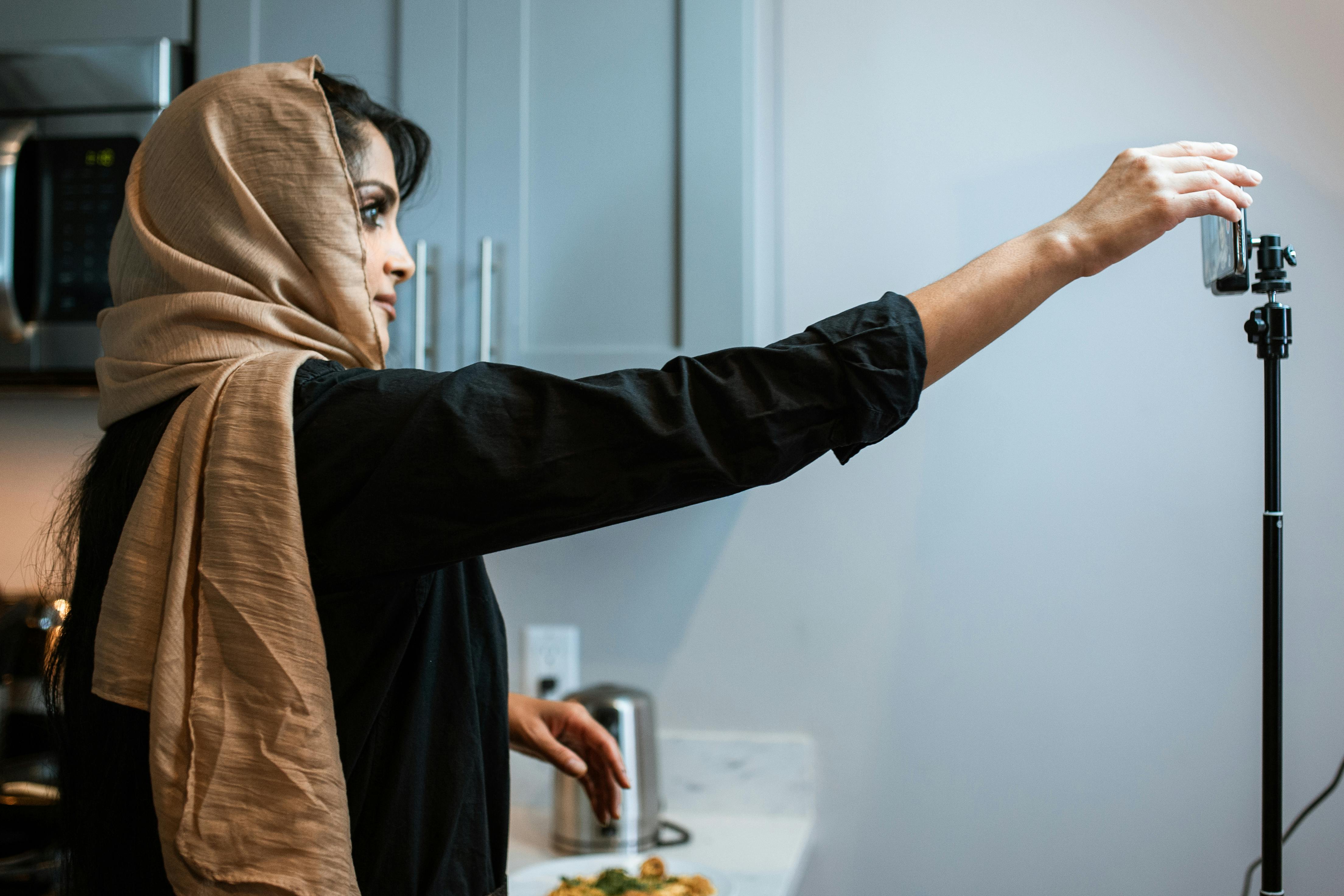 woman adjusting her phone for recording