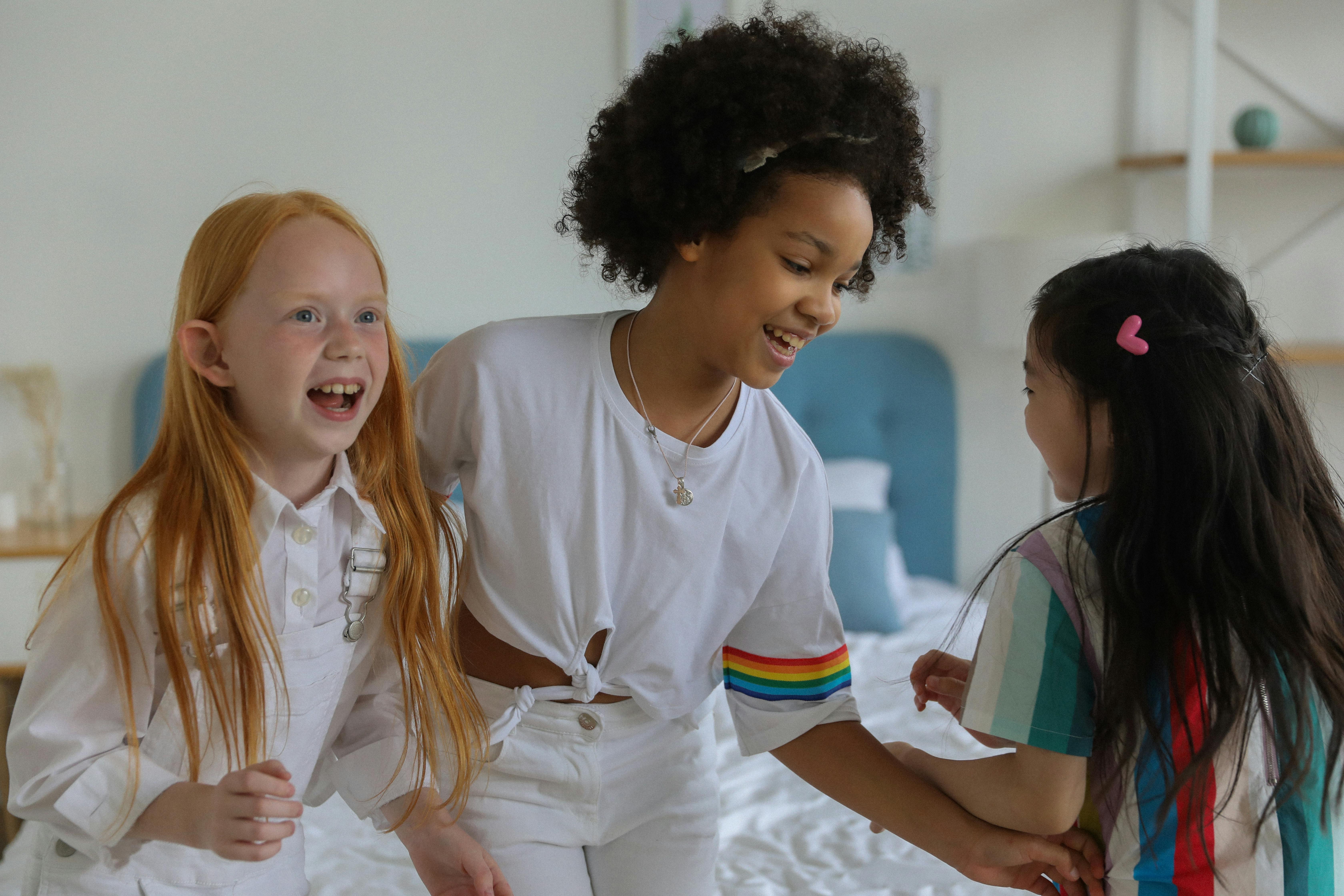 happy diverse girlfriends having fun at home