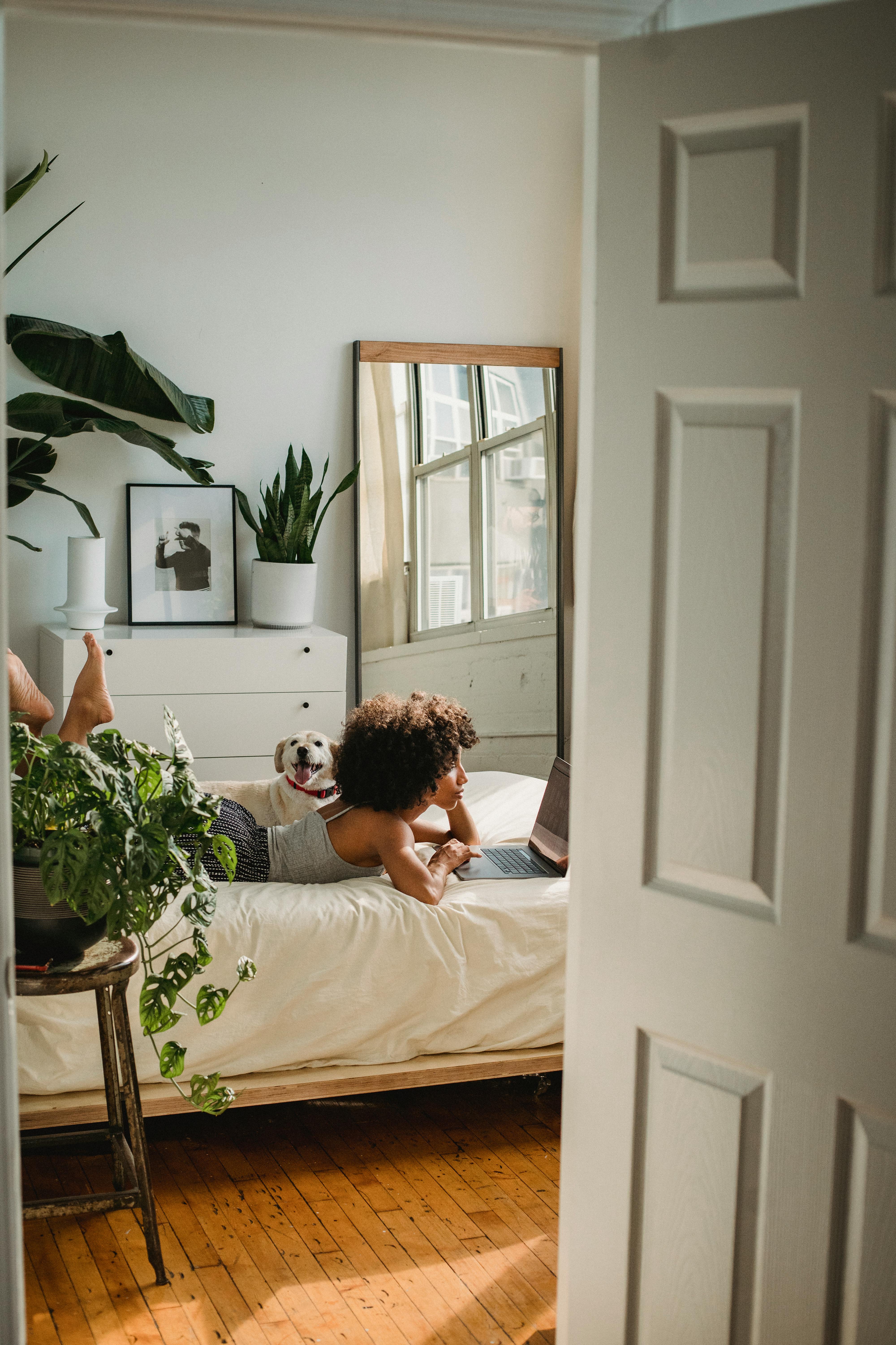 woman with dog in cozy bedroom