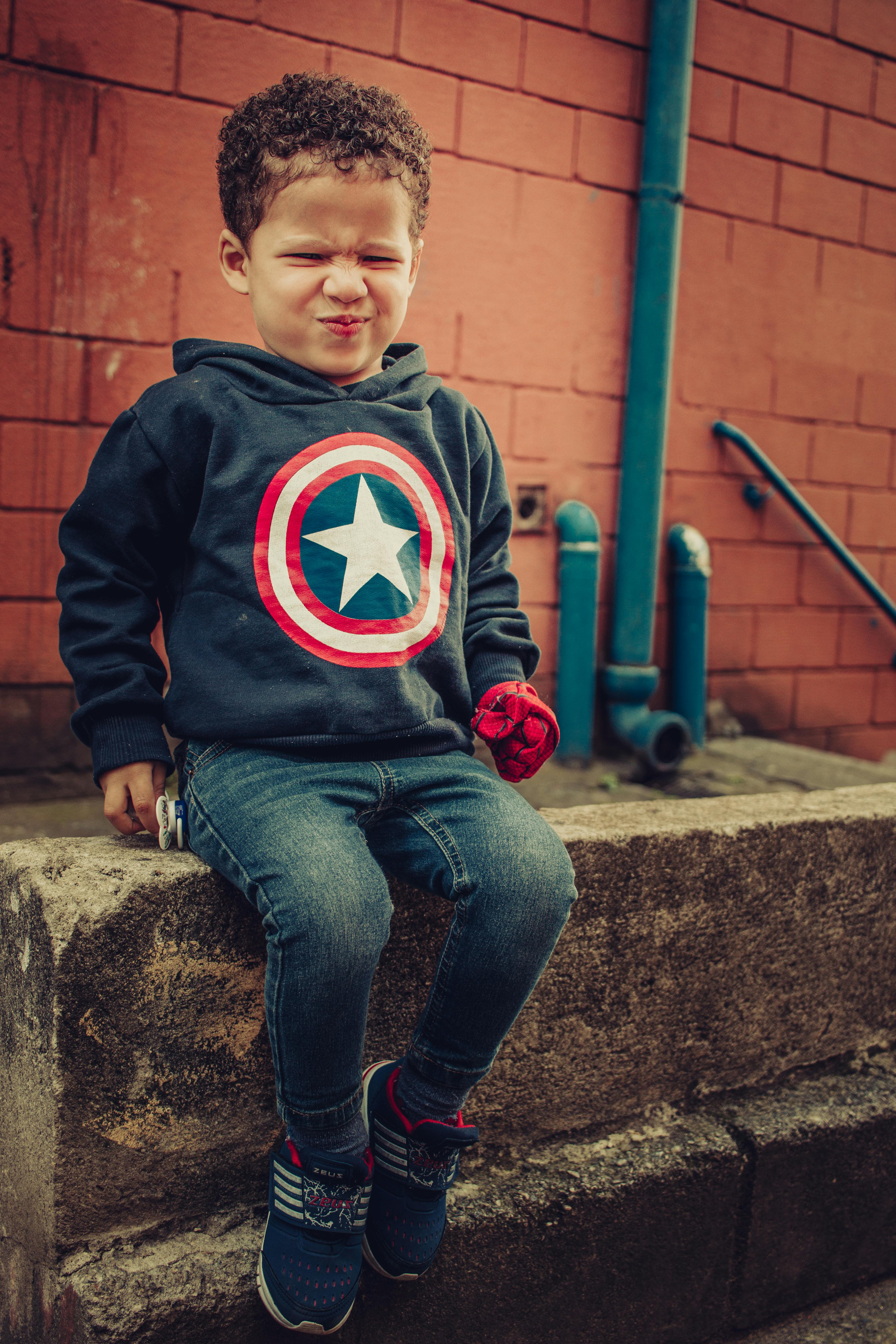 cute boy sitting on stone border