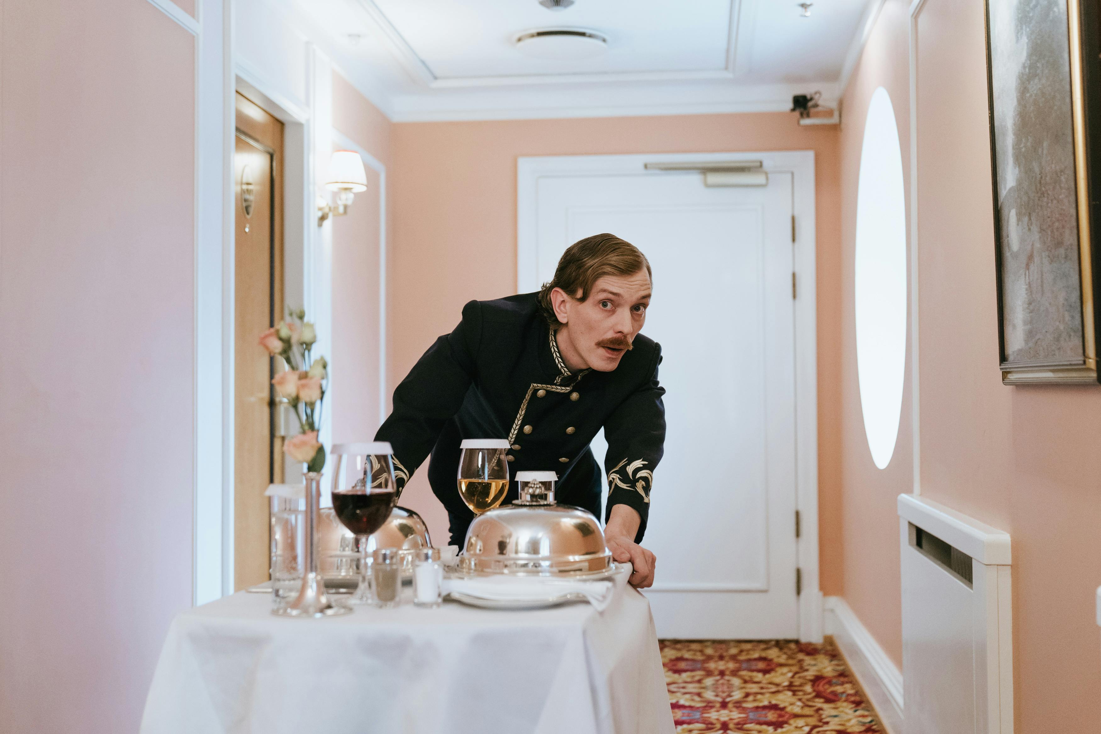 guest service staff pulling a serving tray