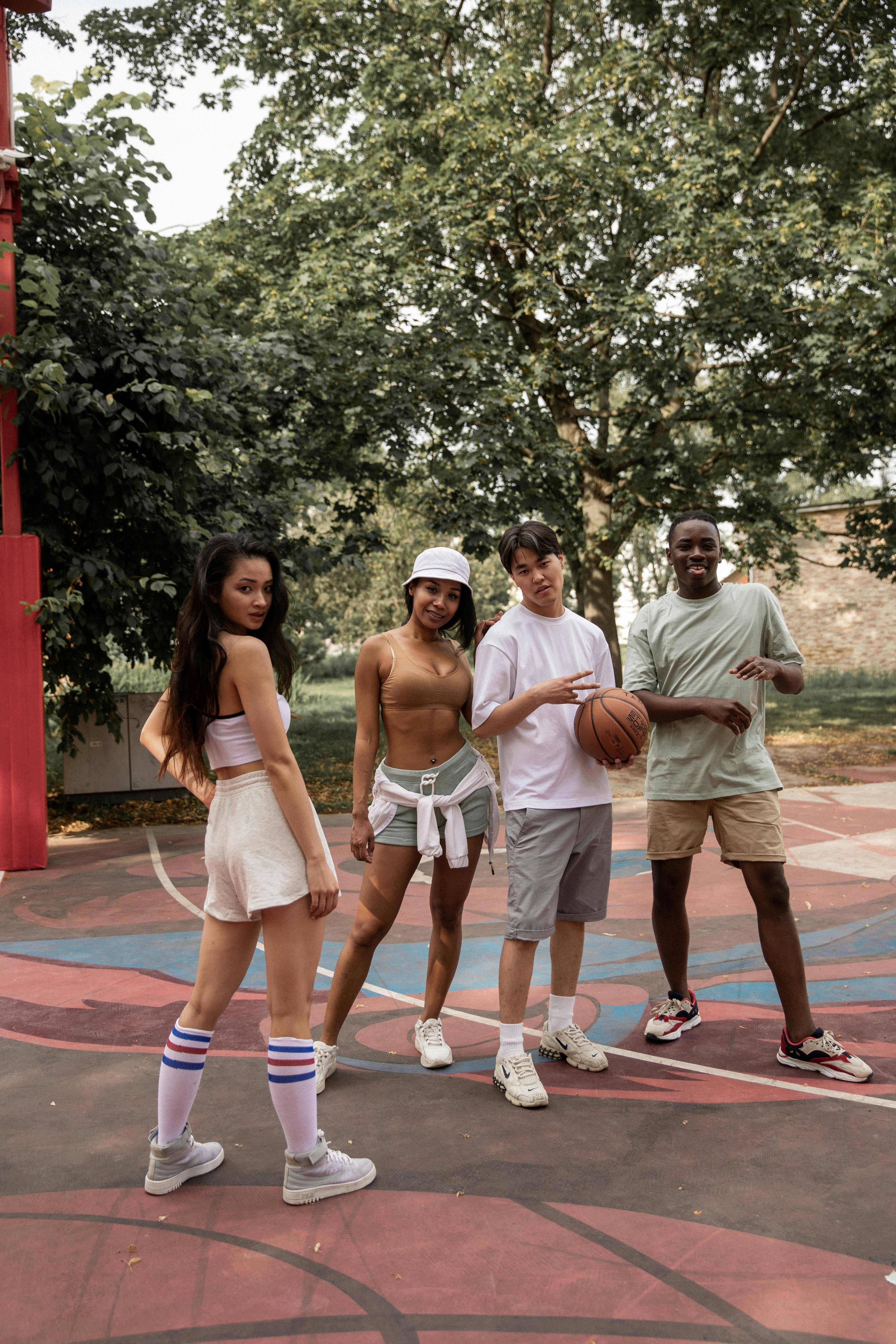 stylish diverse friends on basketball court