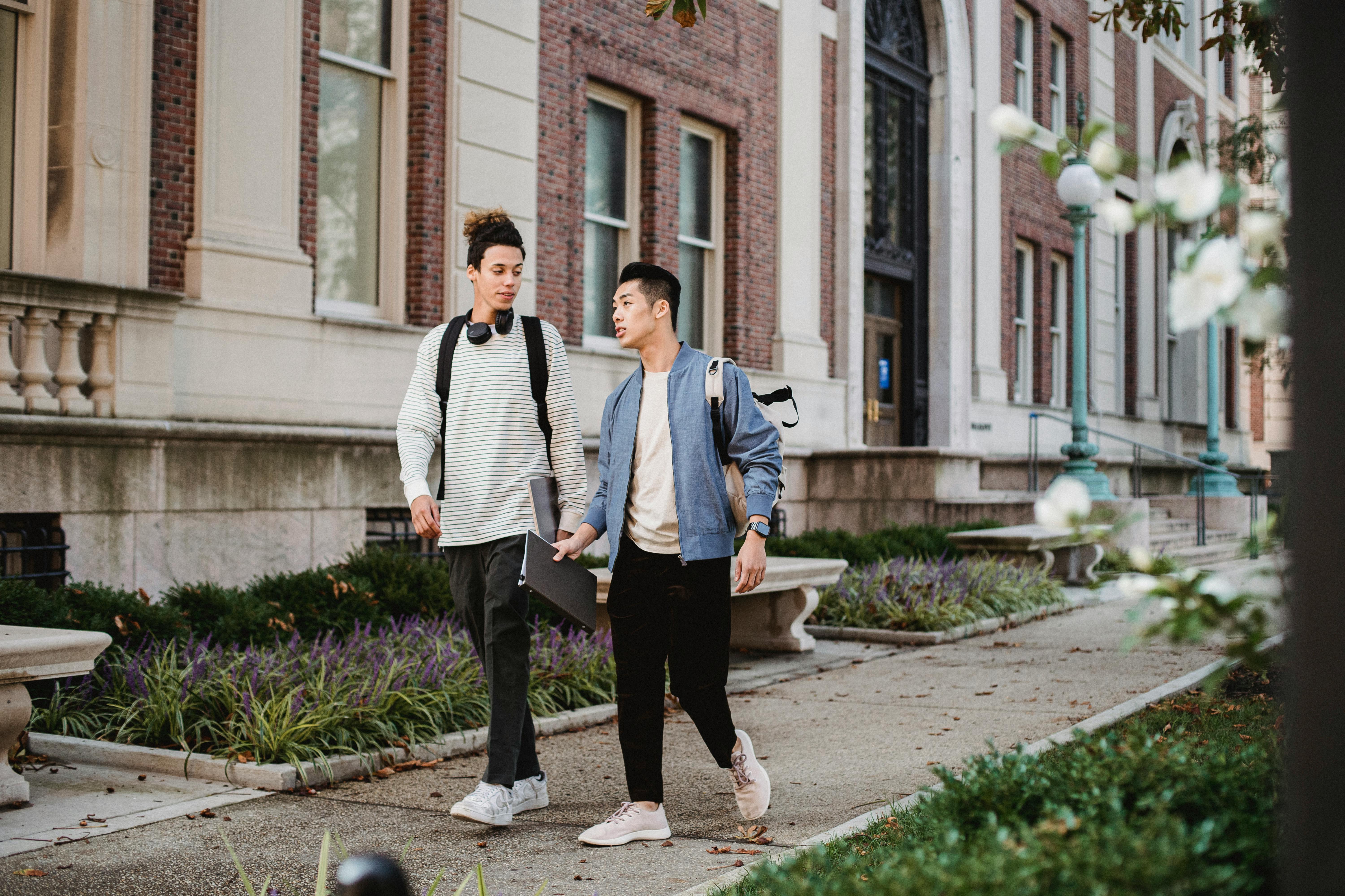 diverse friends walking on street in city