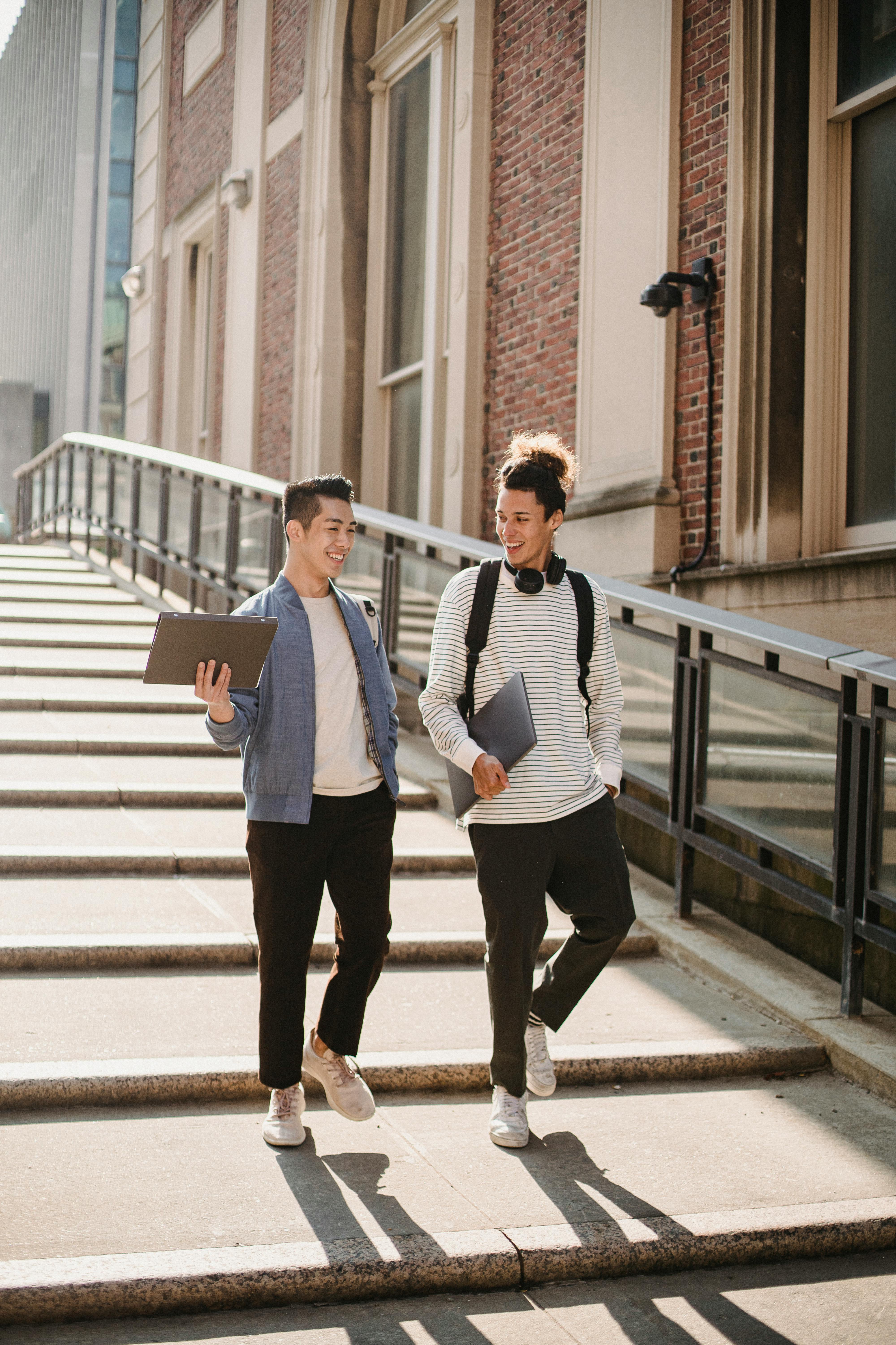 multiethnic students walking along stairway in campus